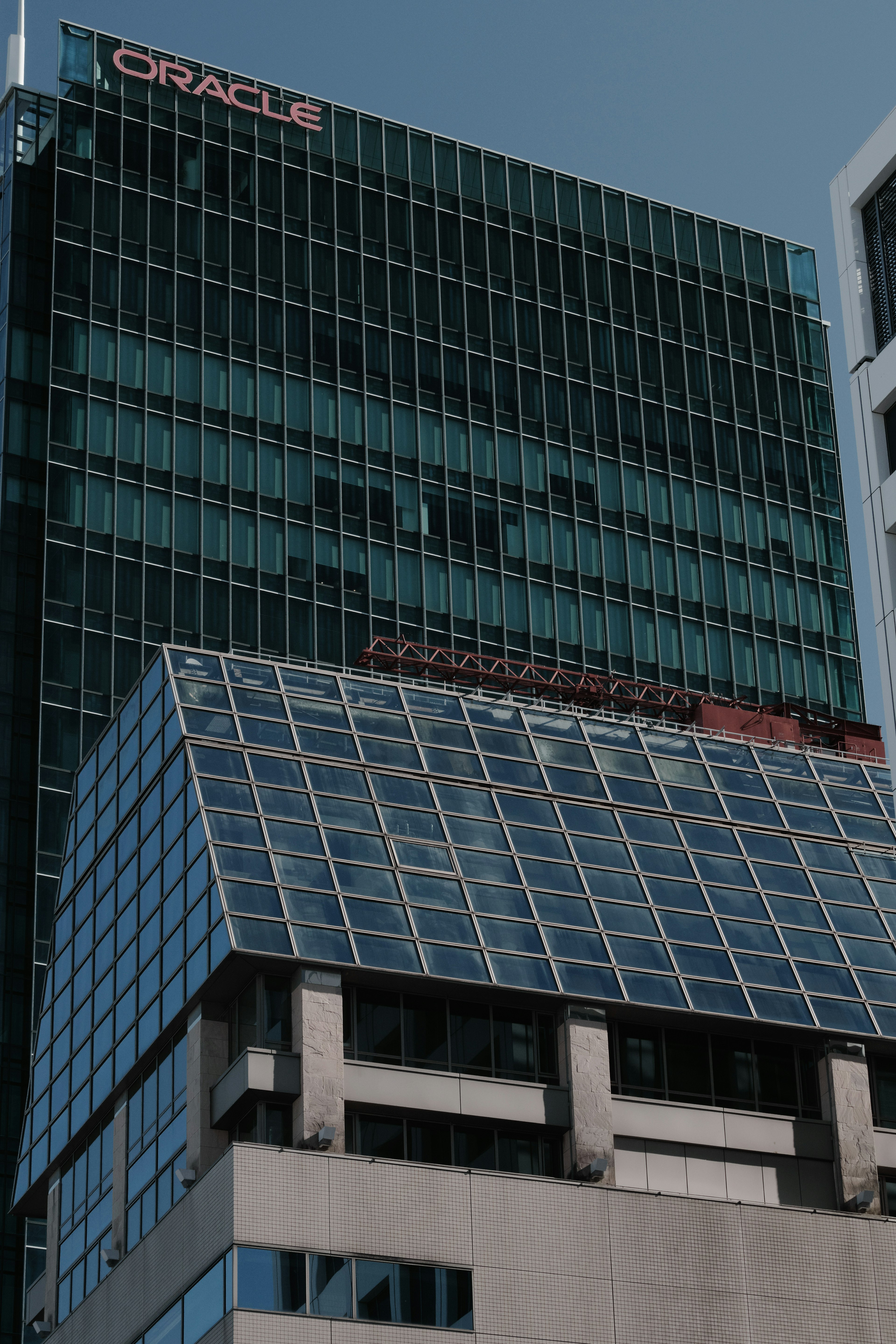 Modern building exterior featuring Oracle logo and glass design