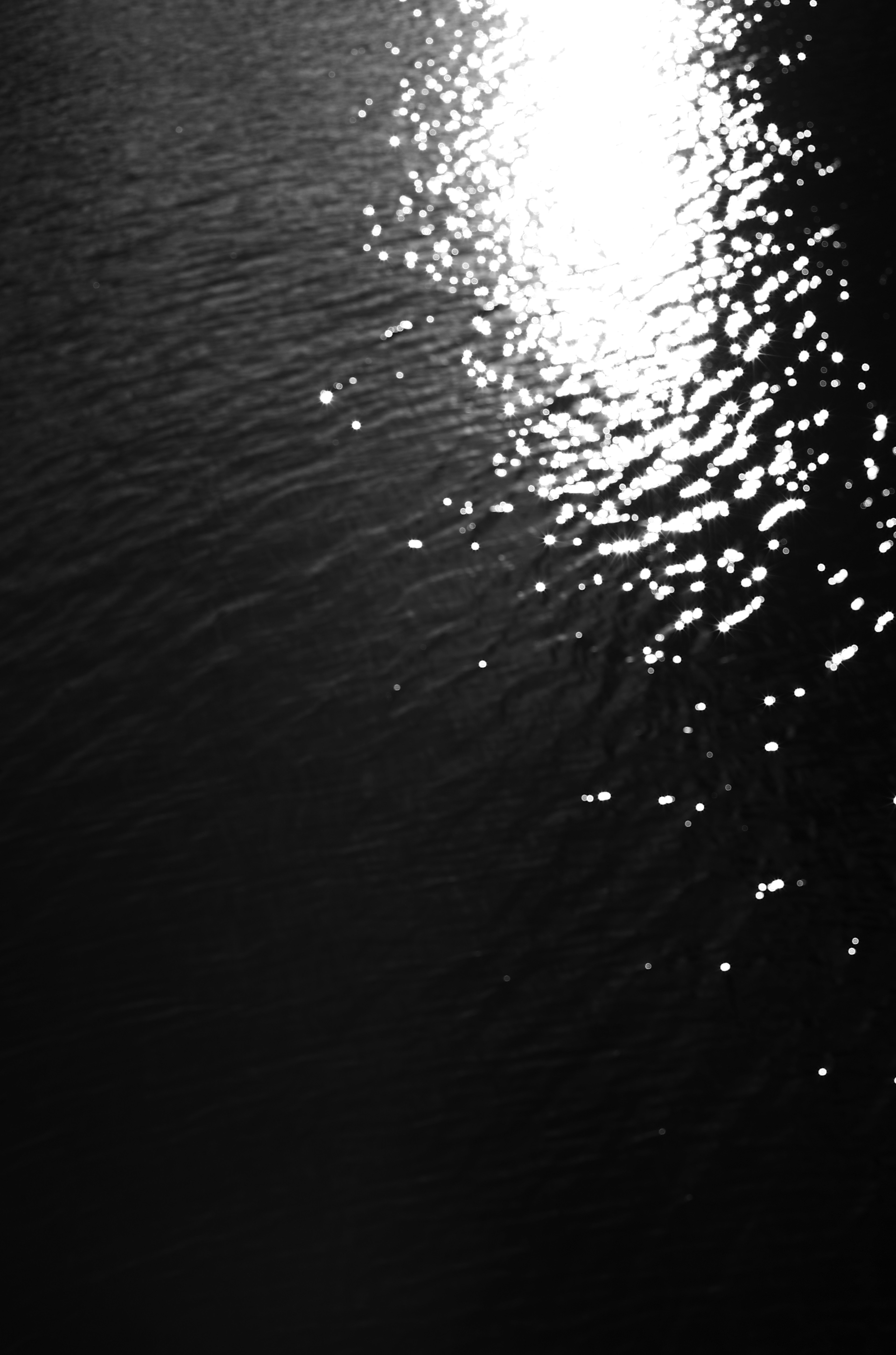 Monochrome image of light reflecting on water surface