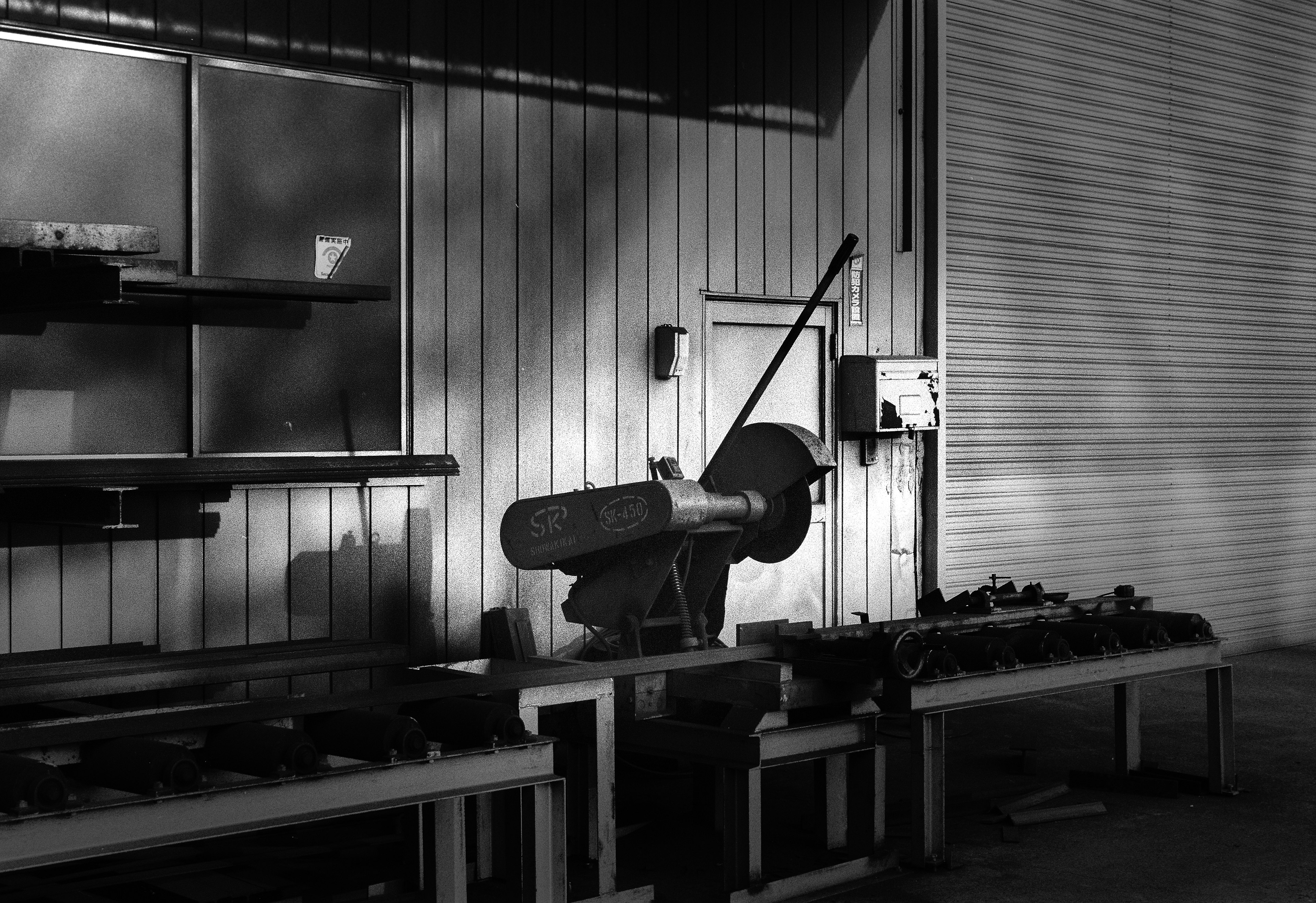 A workshop scene featuring machinery and tools arranged on a workbench