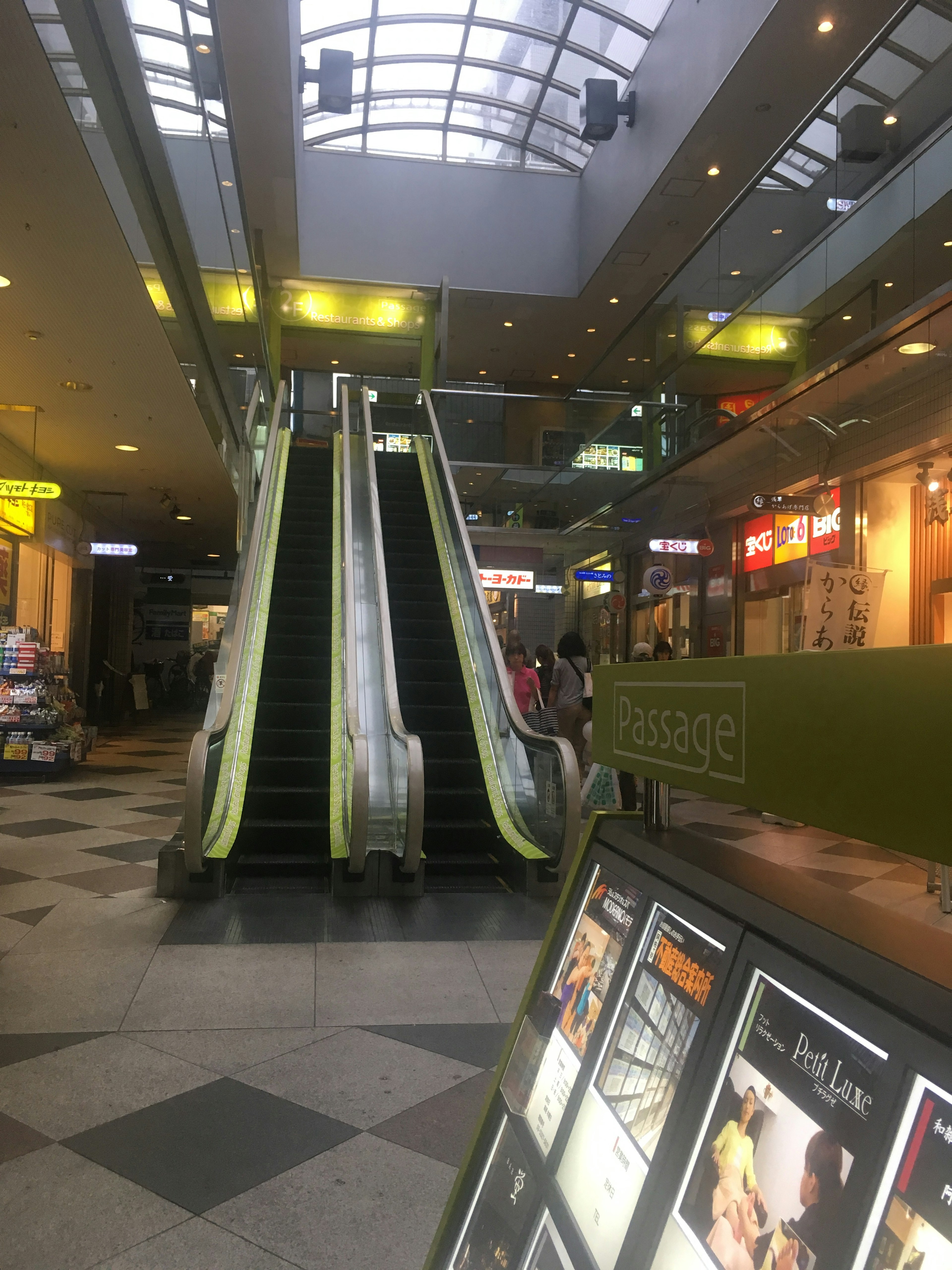 Shopping mall escalators with bright lighting