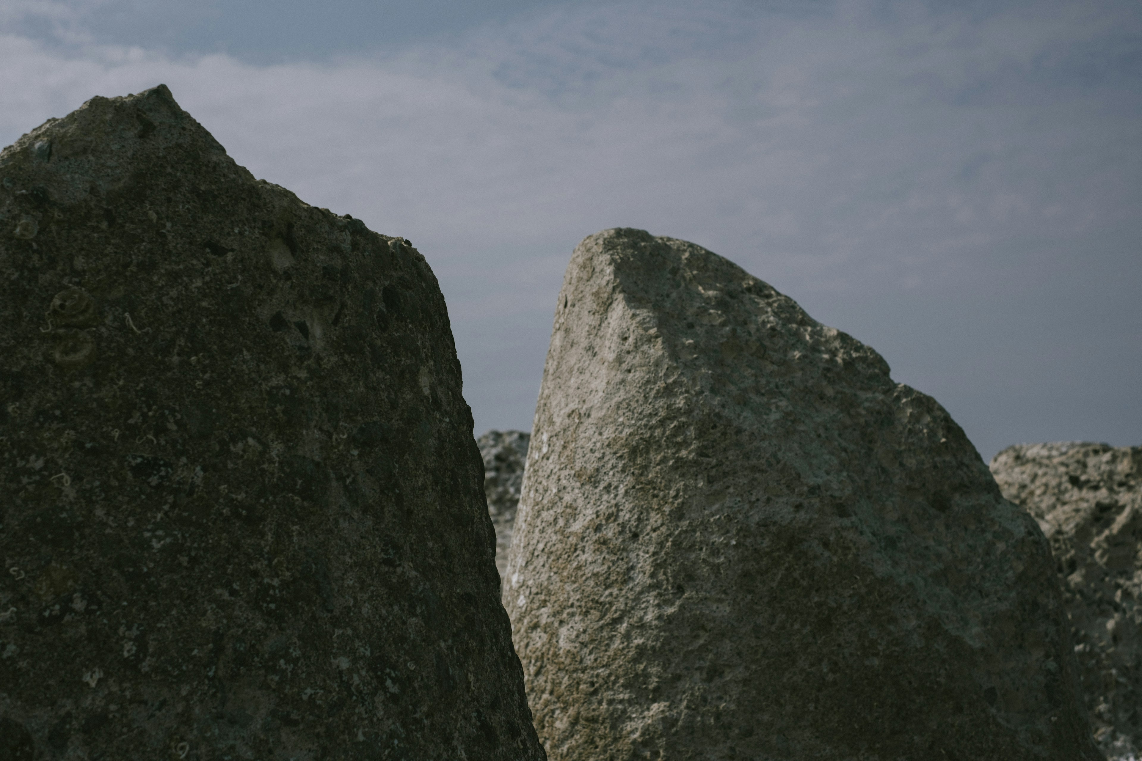 Close-up of large rocks under a blue sky