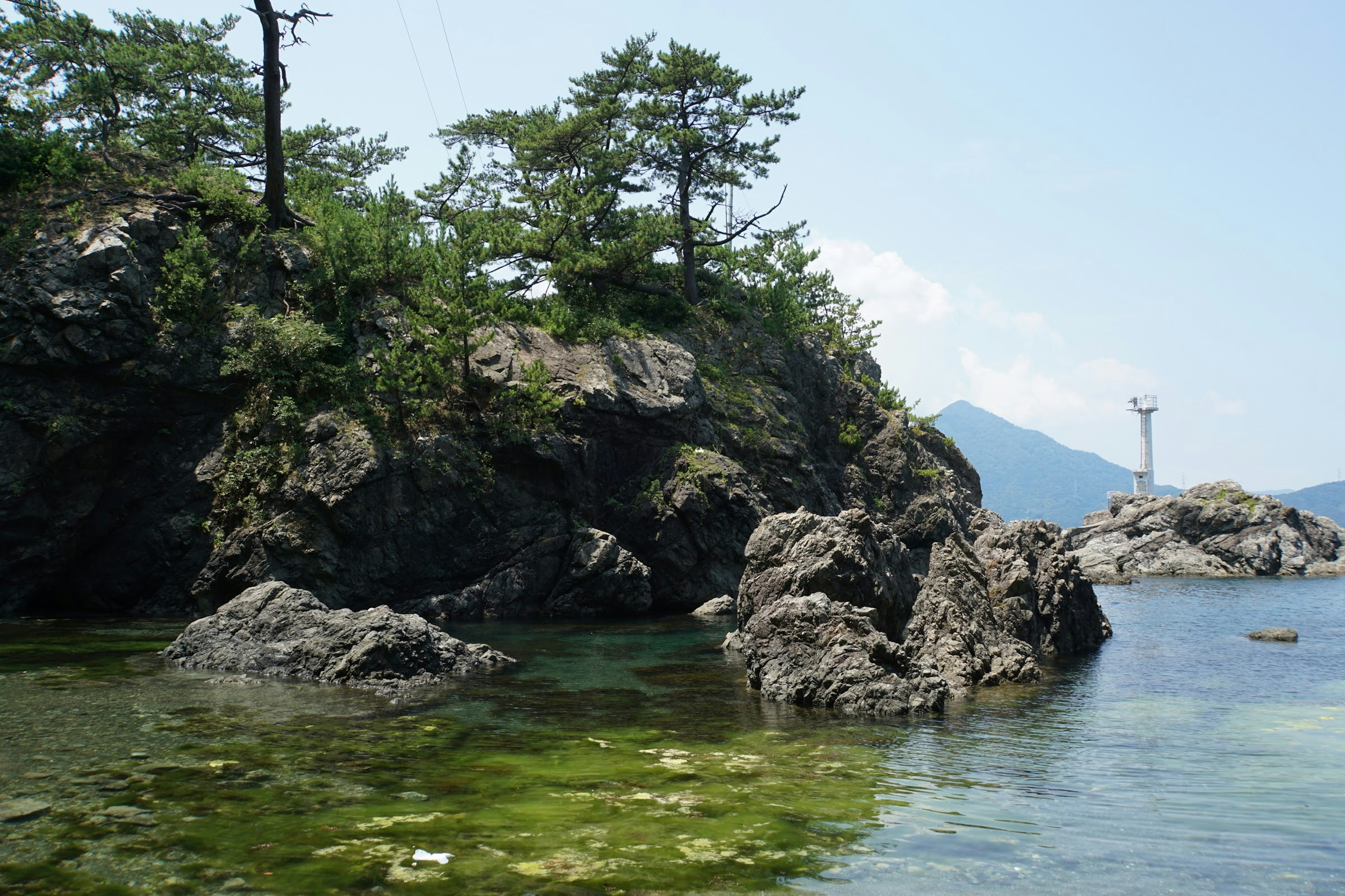 Serene coastal landscape with rocks and trees