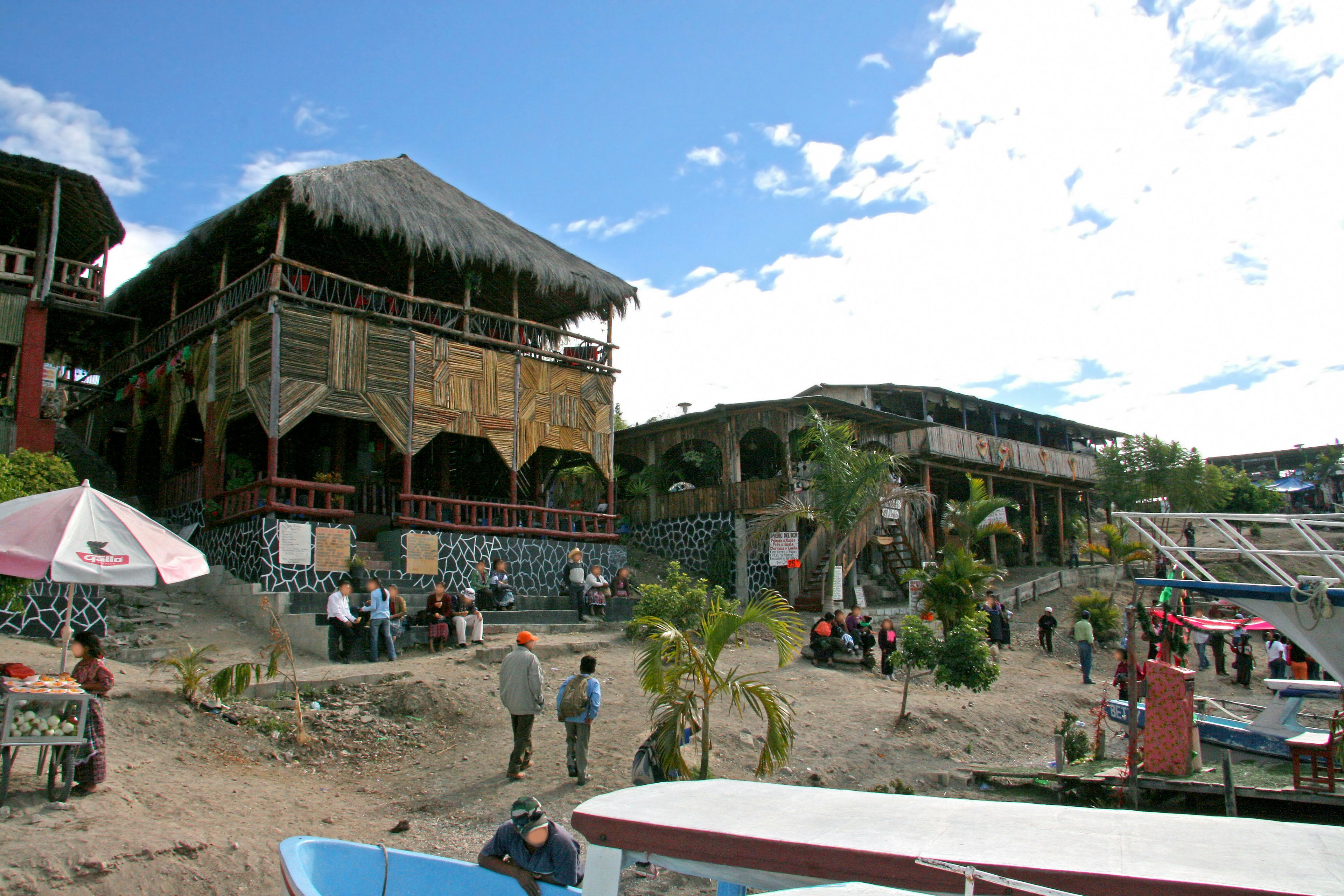 Lakeside resort with wooden buildings and visitors