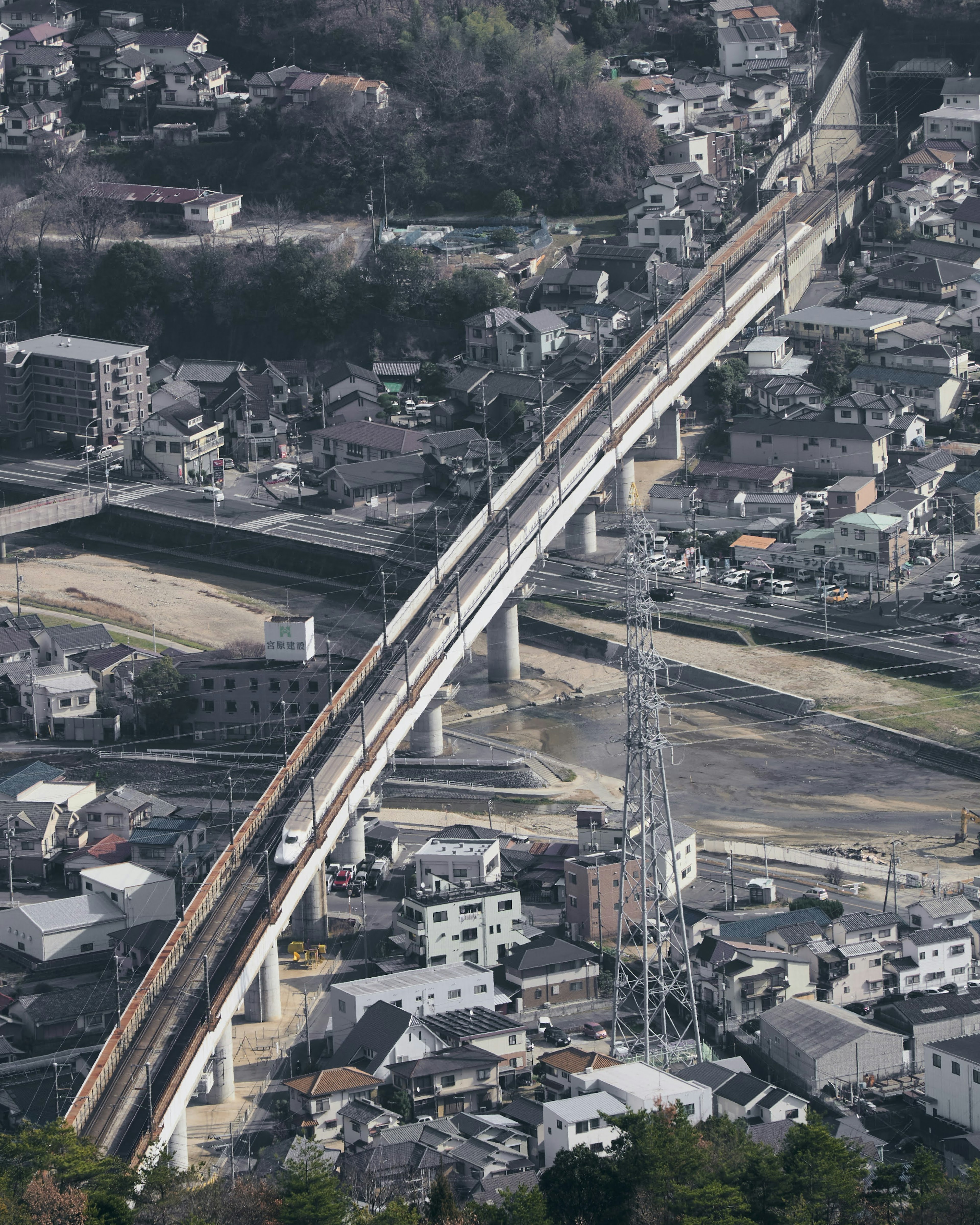 A view of an elevated train traveling over a cityscape