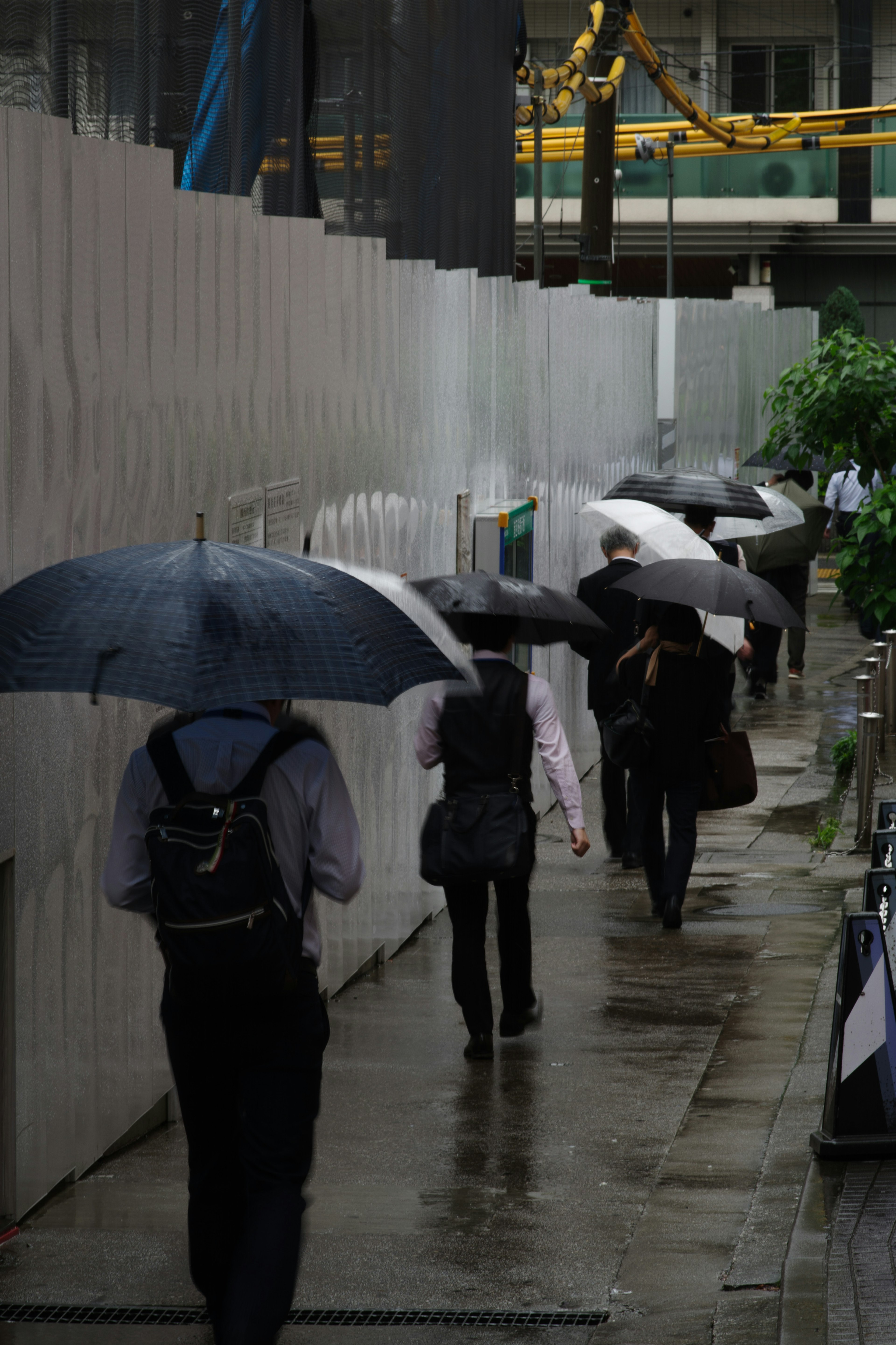 People walking with umbrellas in an urban setting