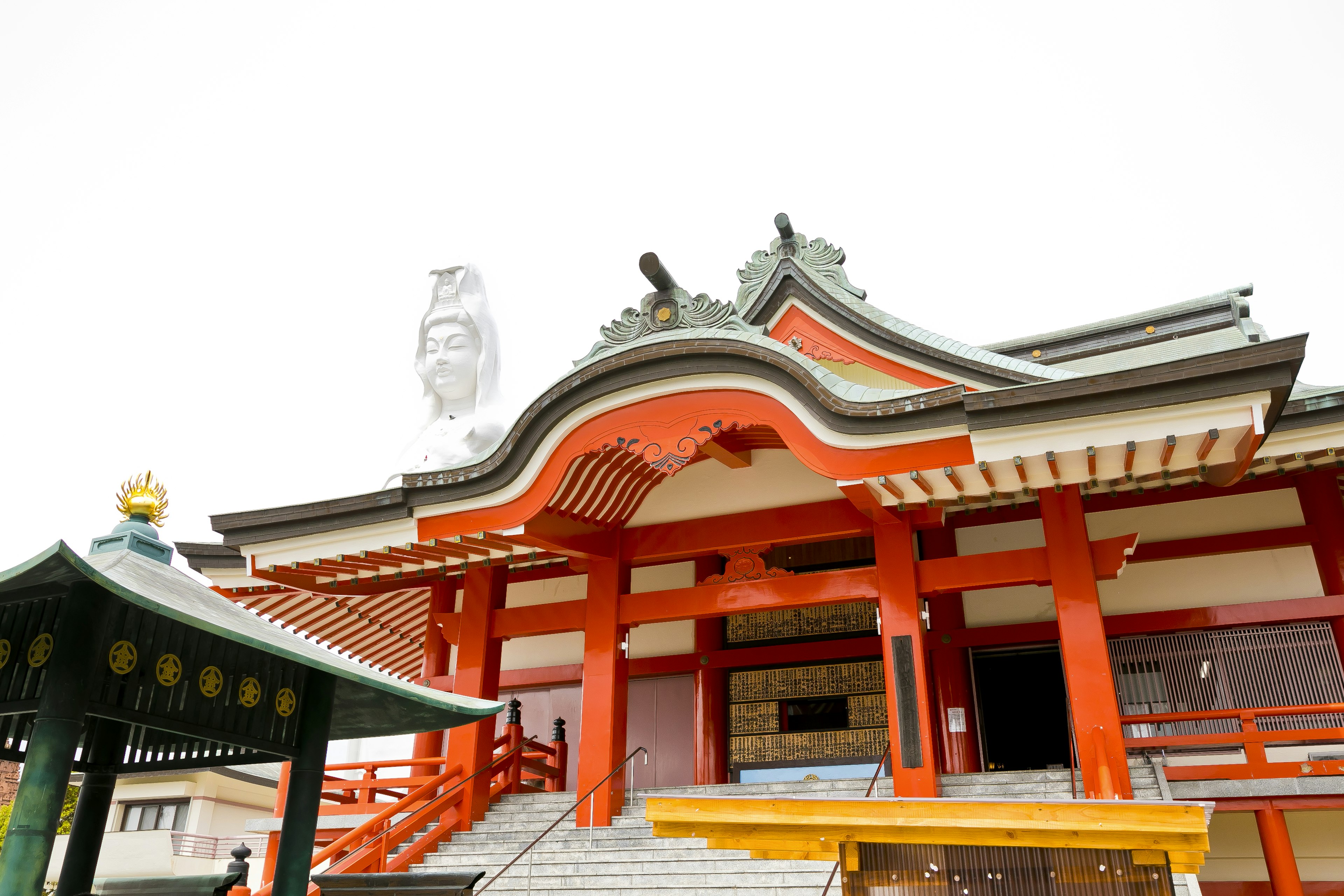 Traditional shrine building with red roof and decorative elements