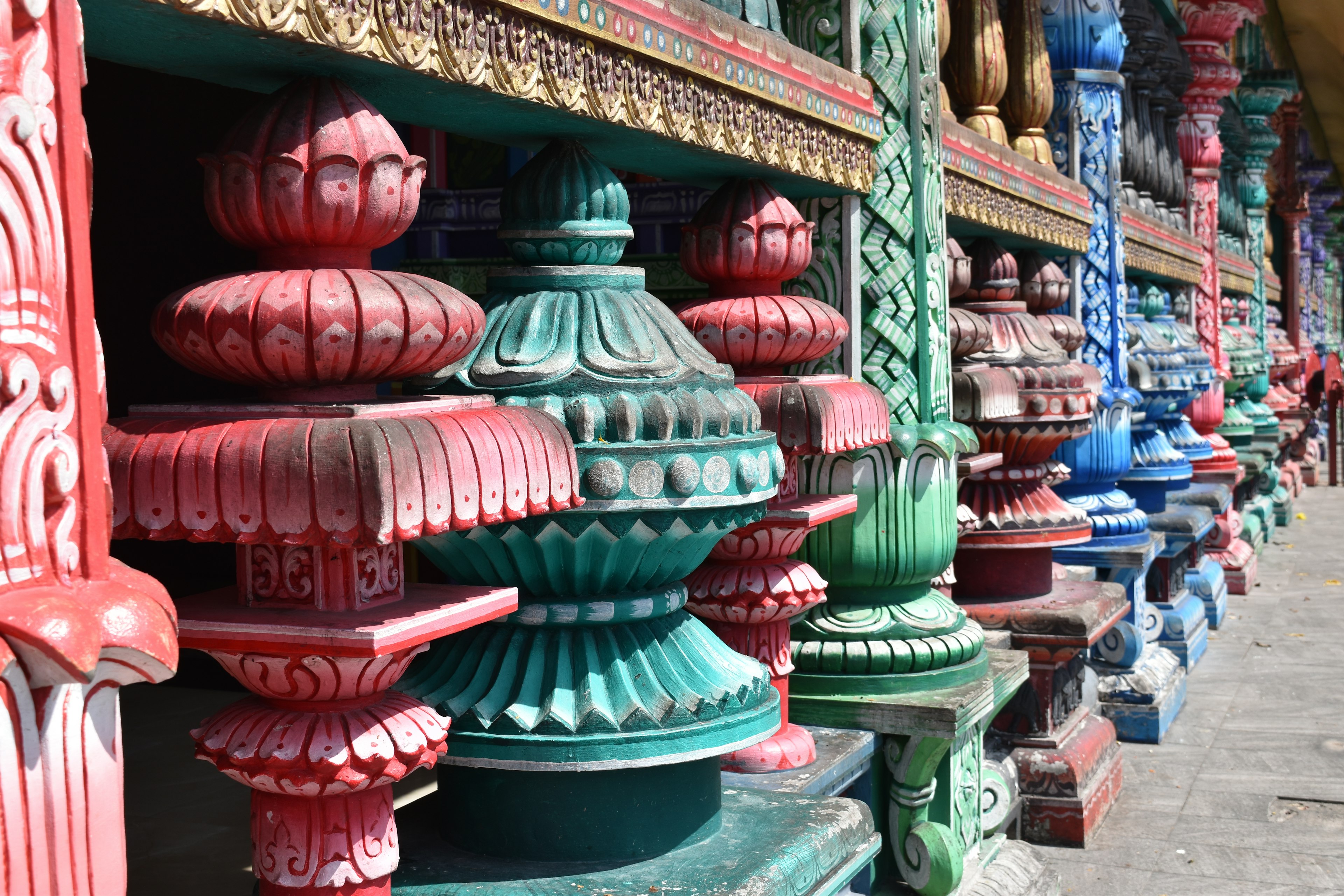 Colorful decorative pillars with intricate details featuring red, green, and blue hues