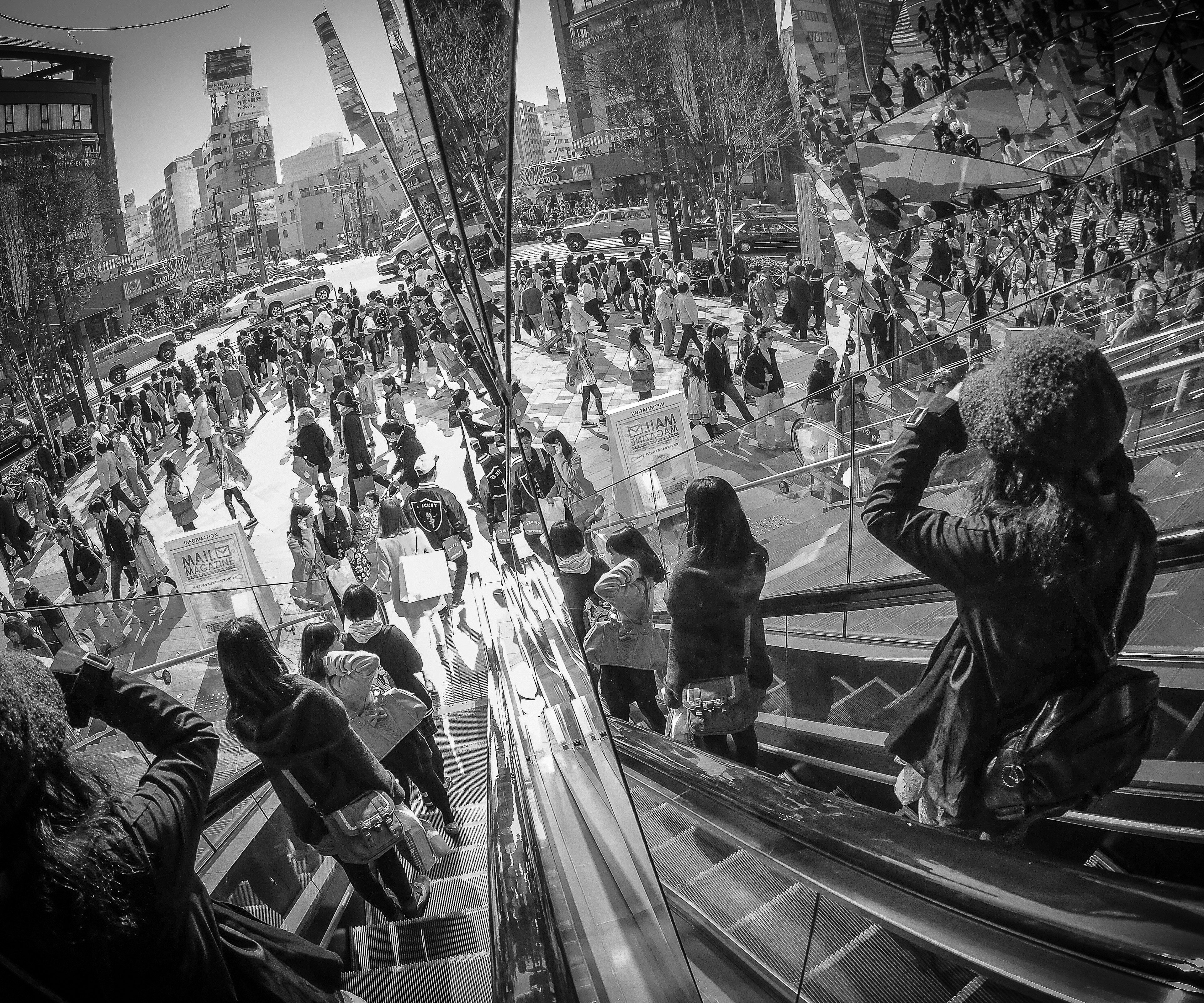 Black and white photo of a bustling urban square filled with people