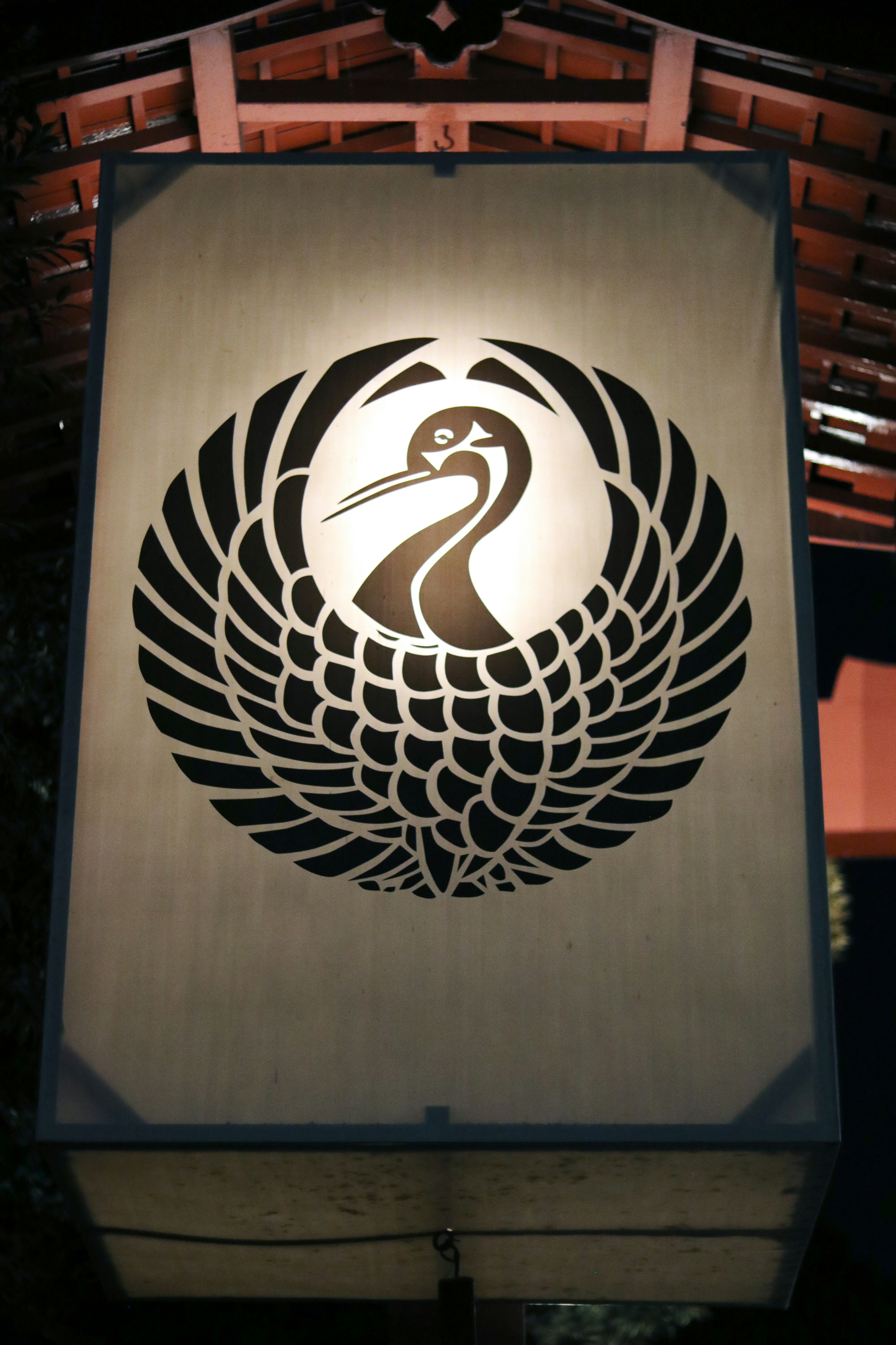 Large lantern featuring a stylized crane symbol