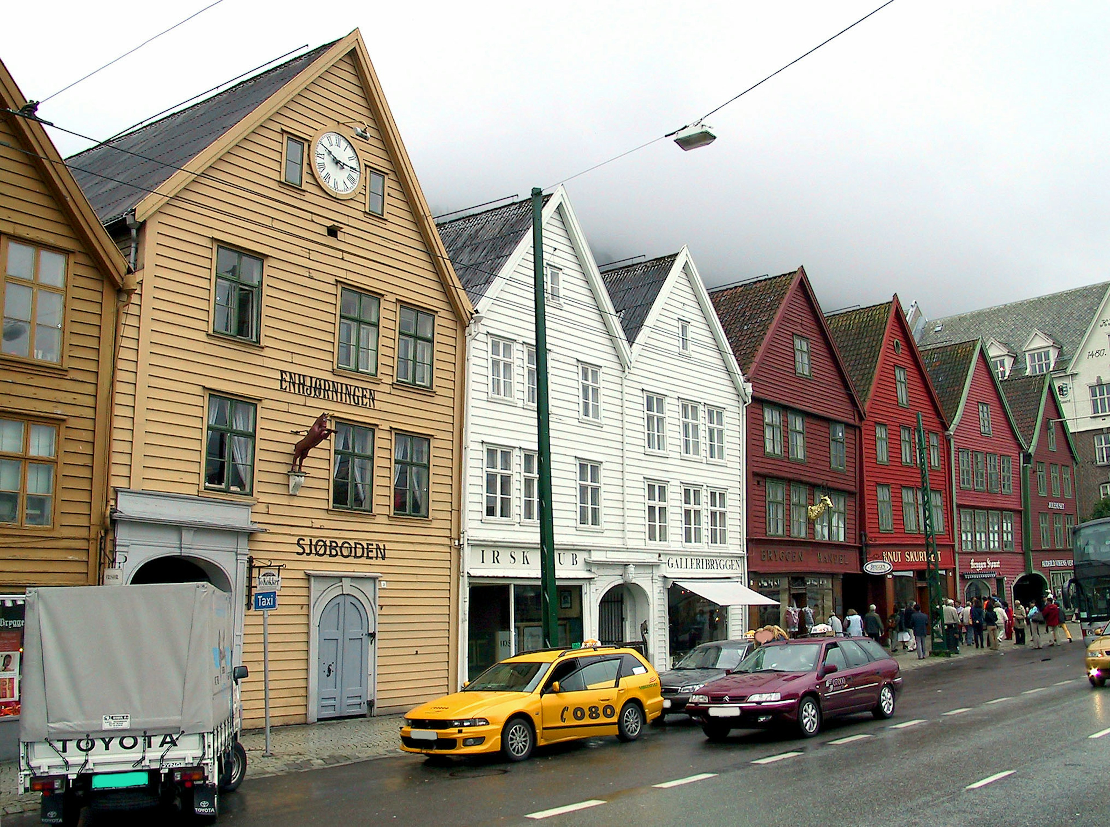 Colorful wooden buildings in Bryggen district with street view