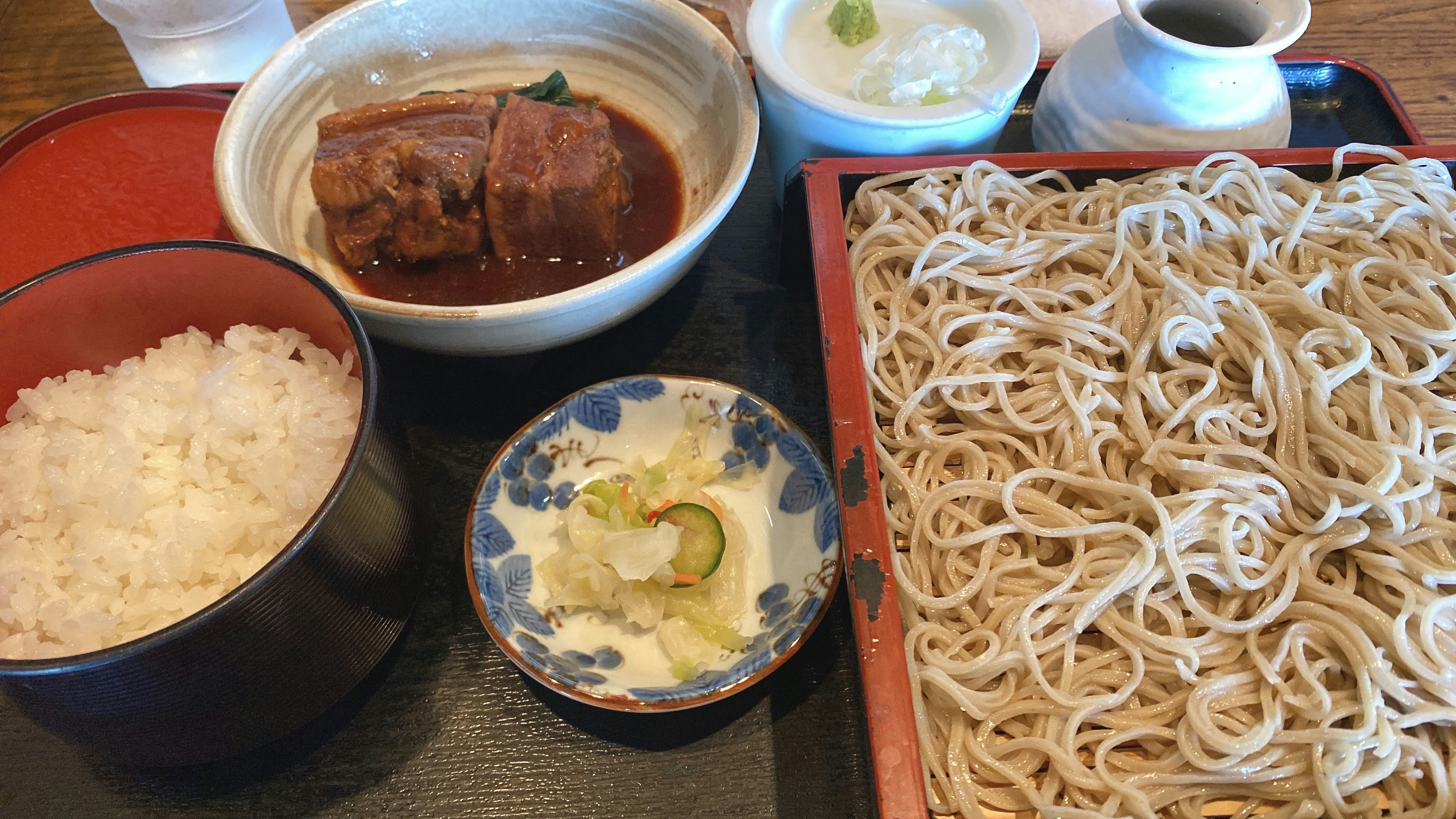 Soba noodles with rice and braised dish in traditional Japanese presentation