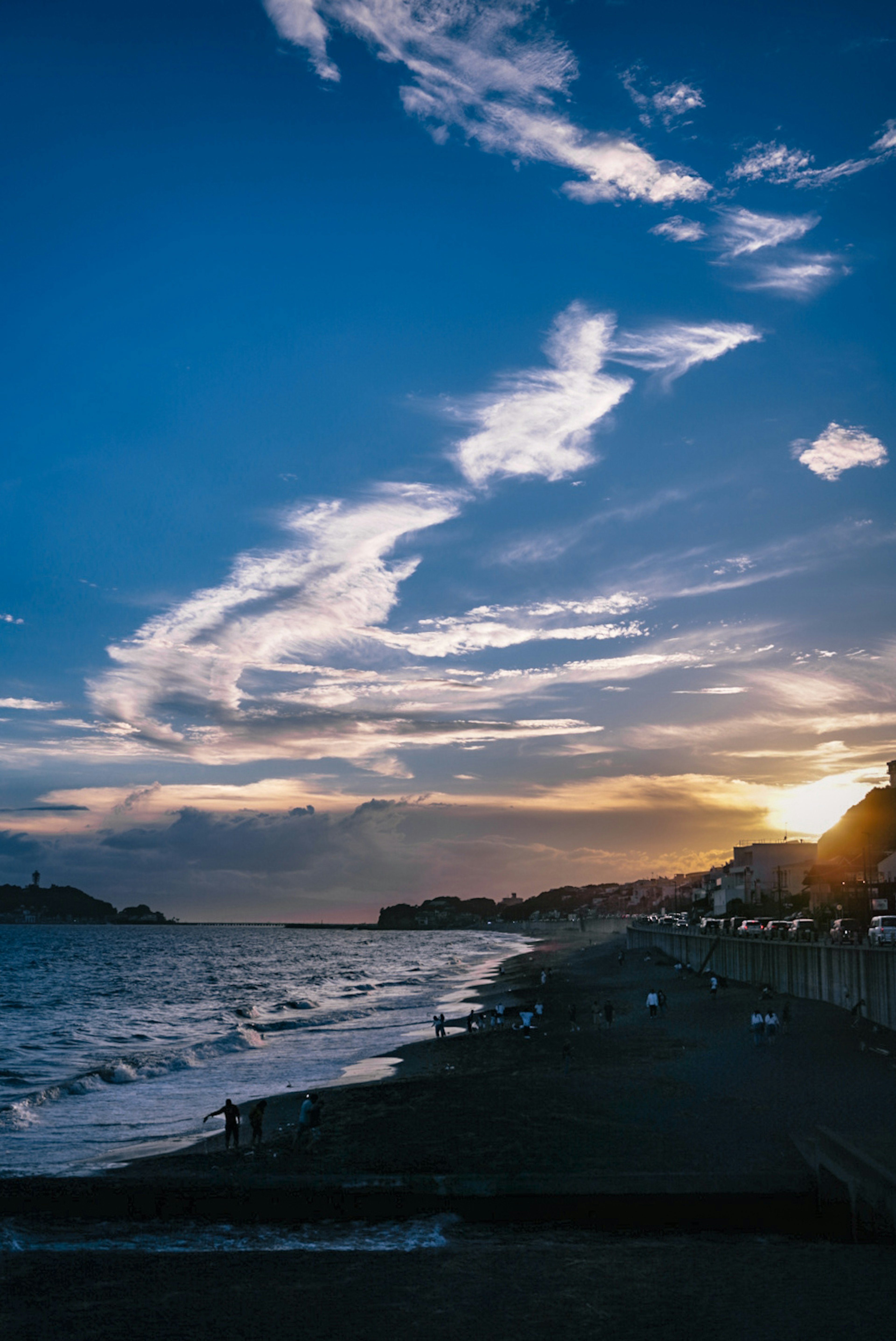 夕日が沈む海岸の美しい風景青い空と白い雲が広がる