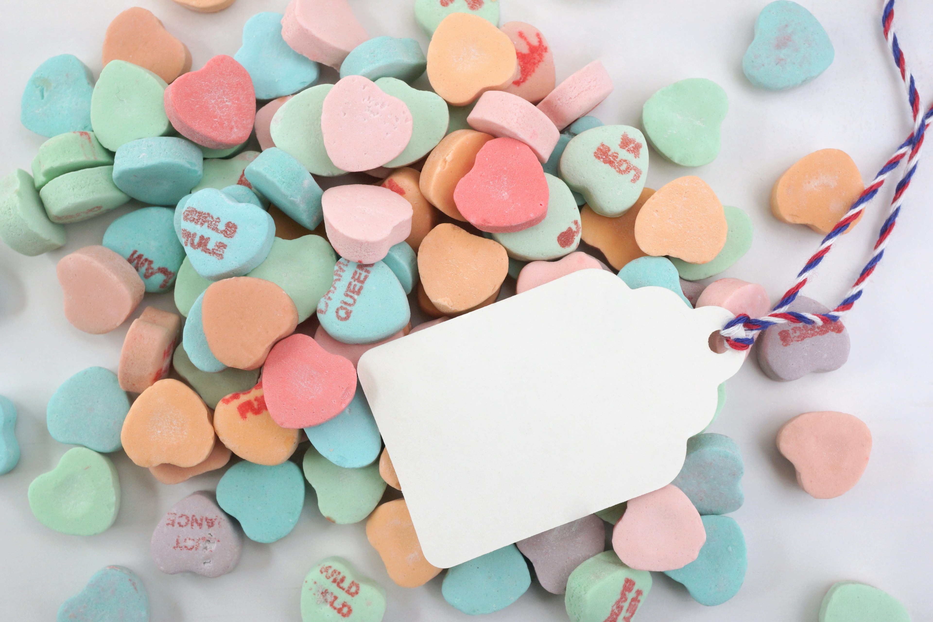 Colorful heart-shaped candies with a blank tag