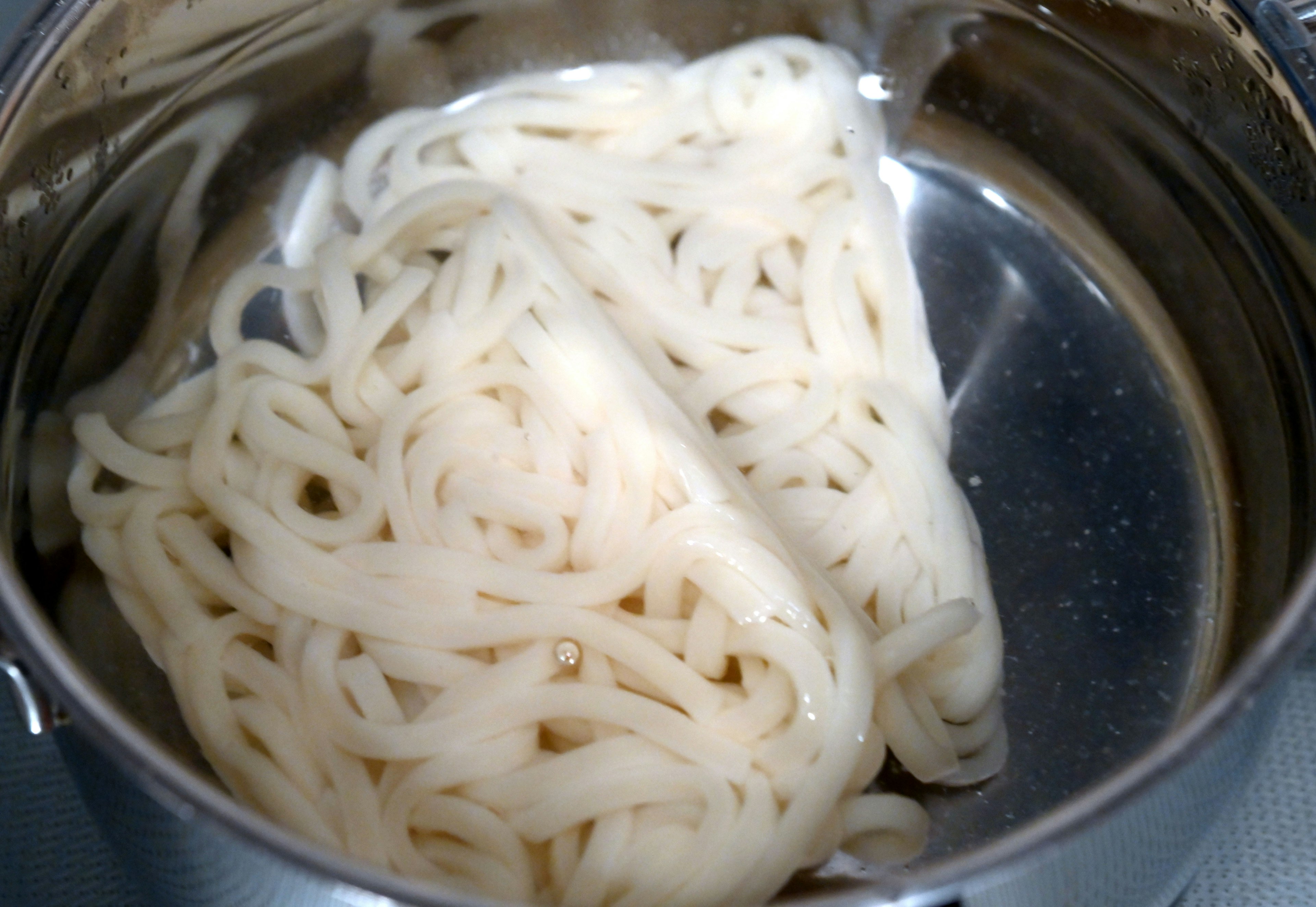 A bundle of white noodles in a pot