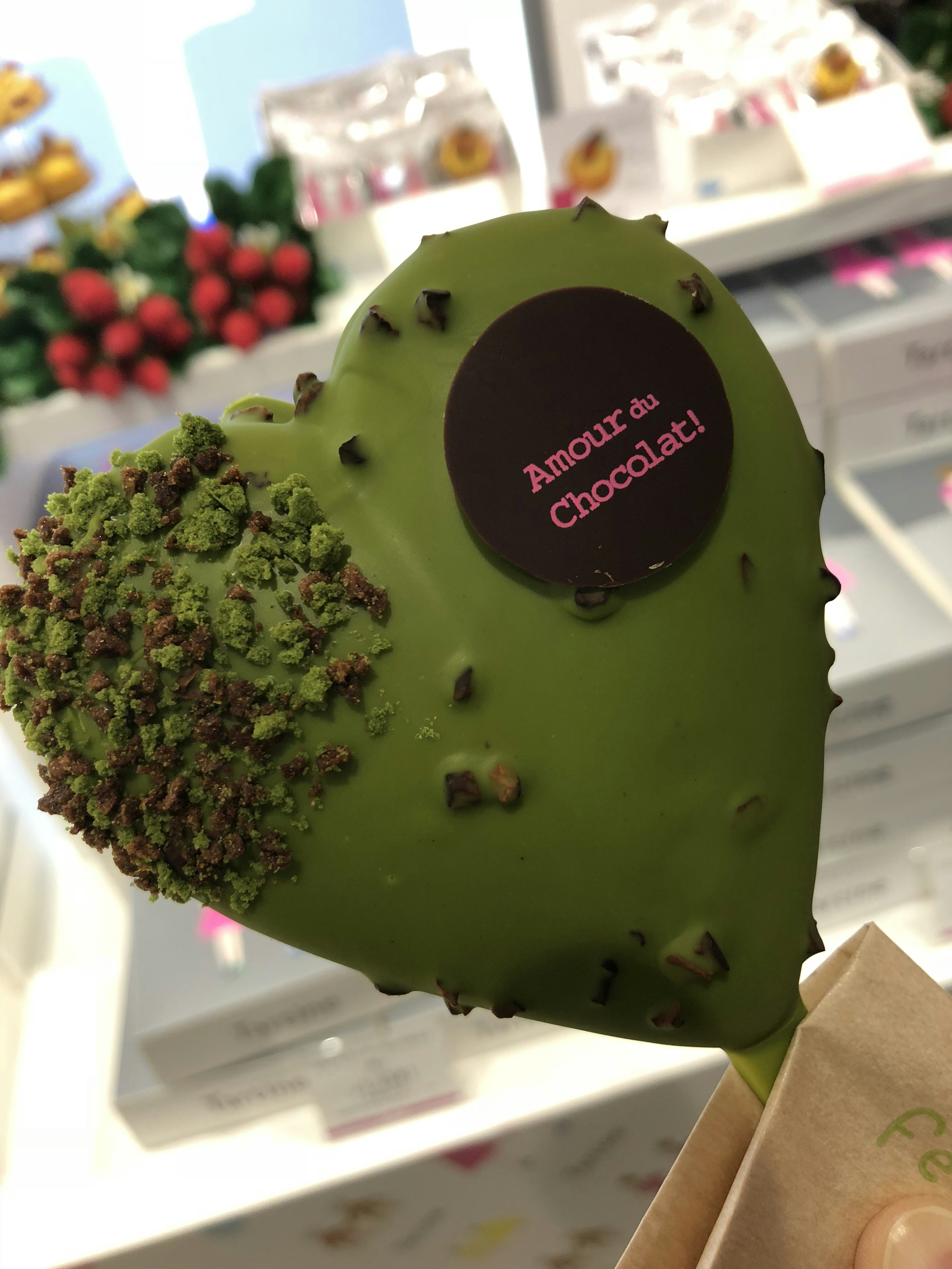 Green heart-shaped chocolate with nut toppings