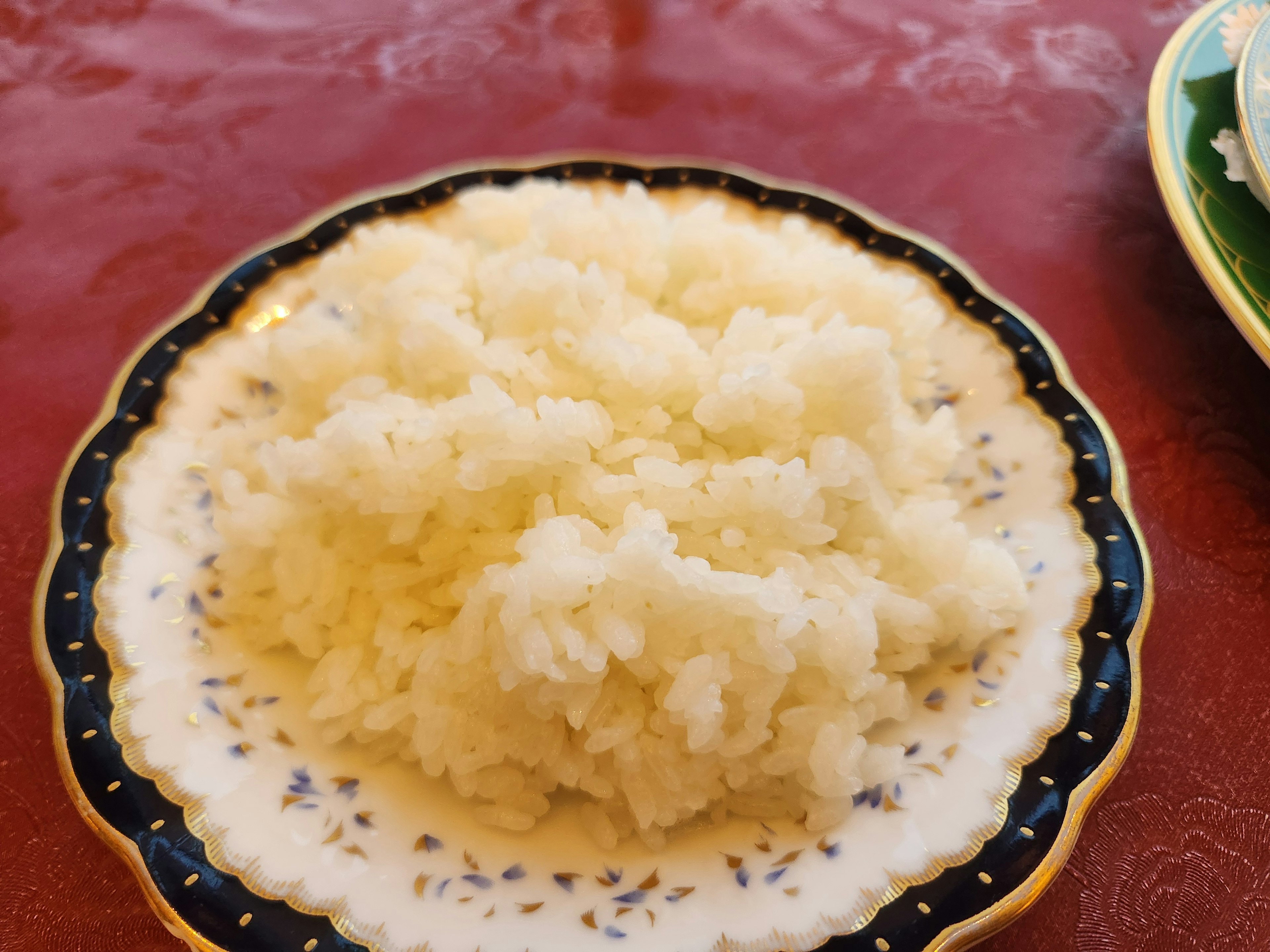 A serving of fluffy white rice on an ornate plate