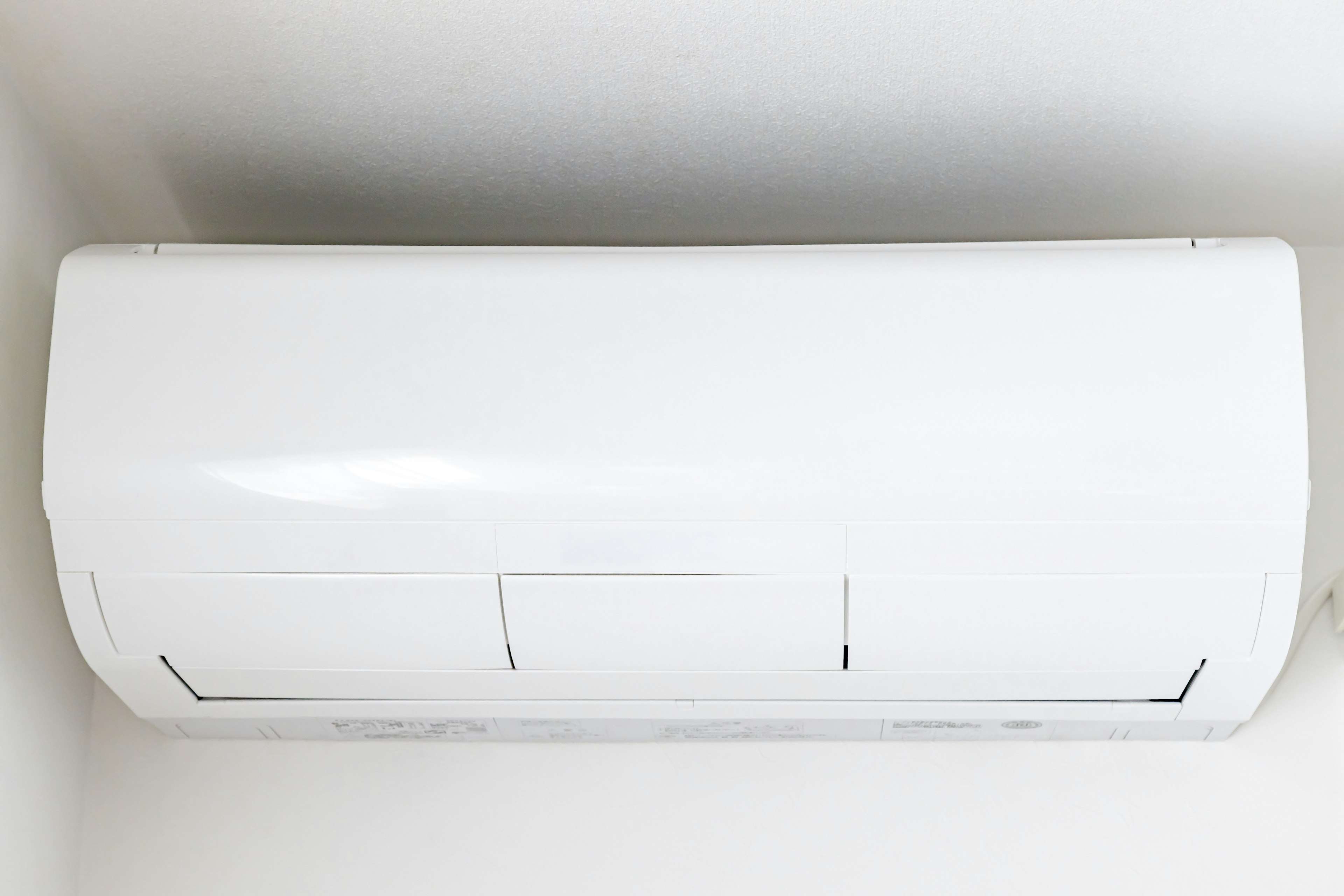 A white air conditioning unit mounted on the wall