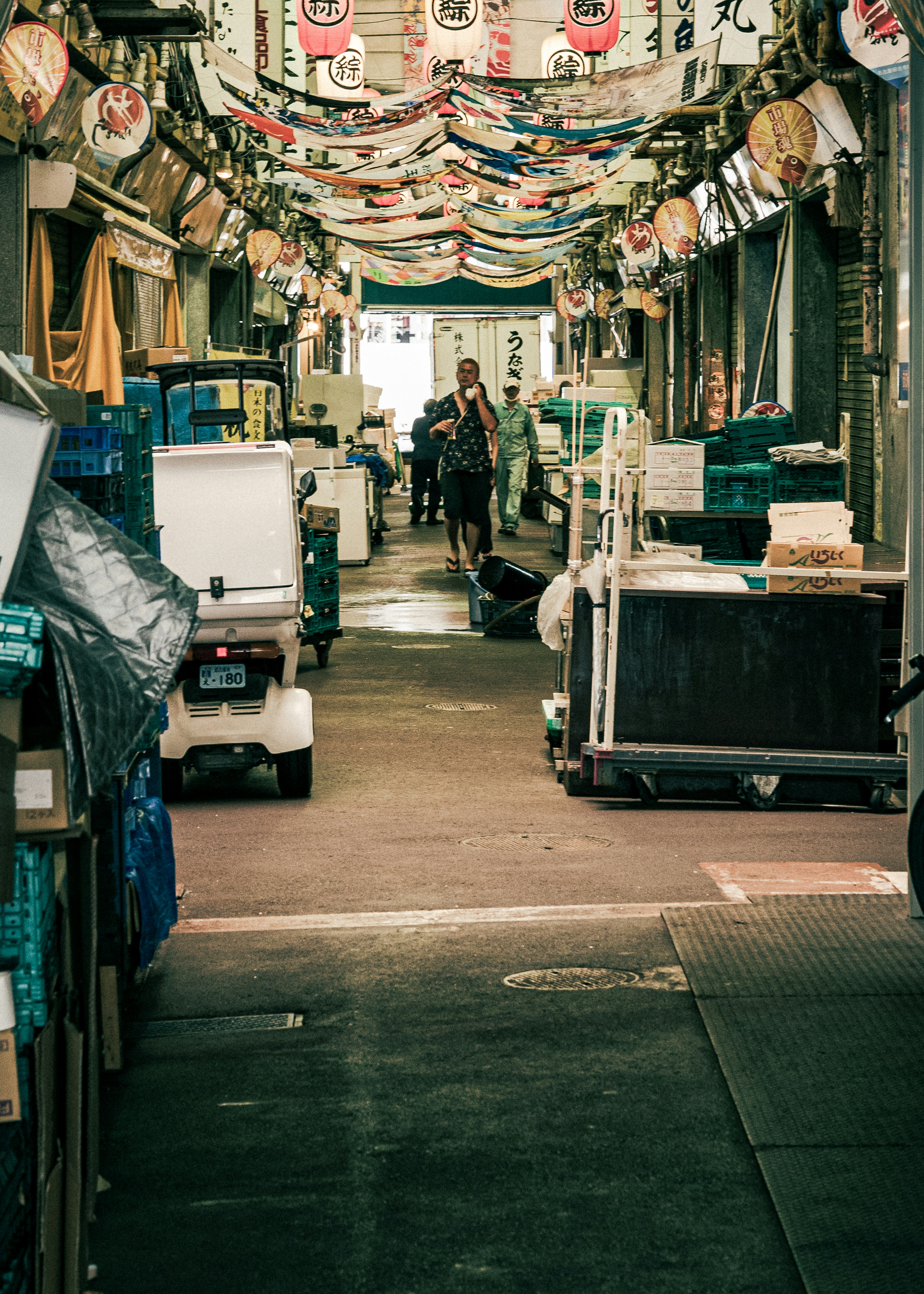 Market aisle filled with goods and people