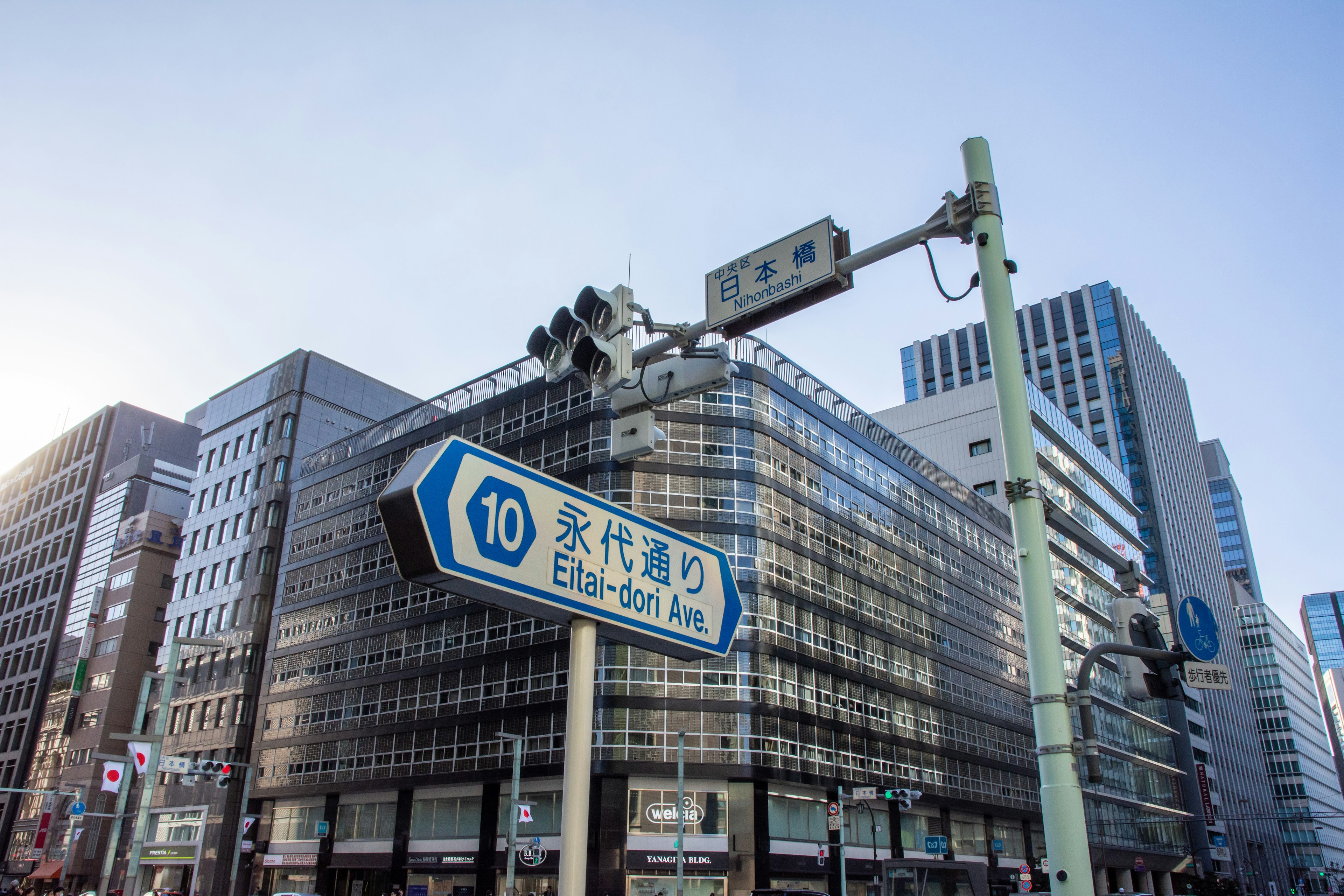 Urban intersection with blue sign and modern buildings