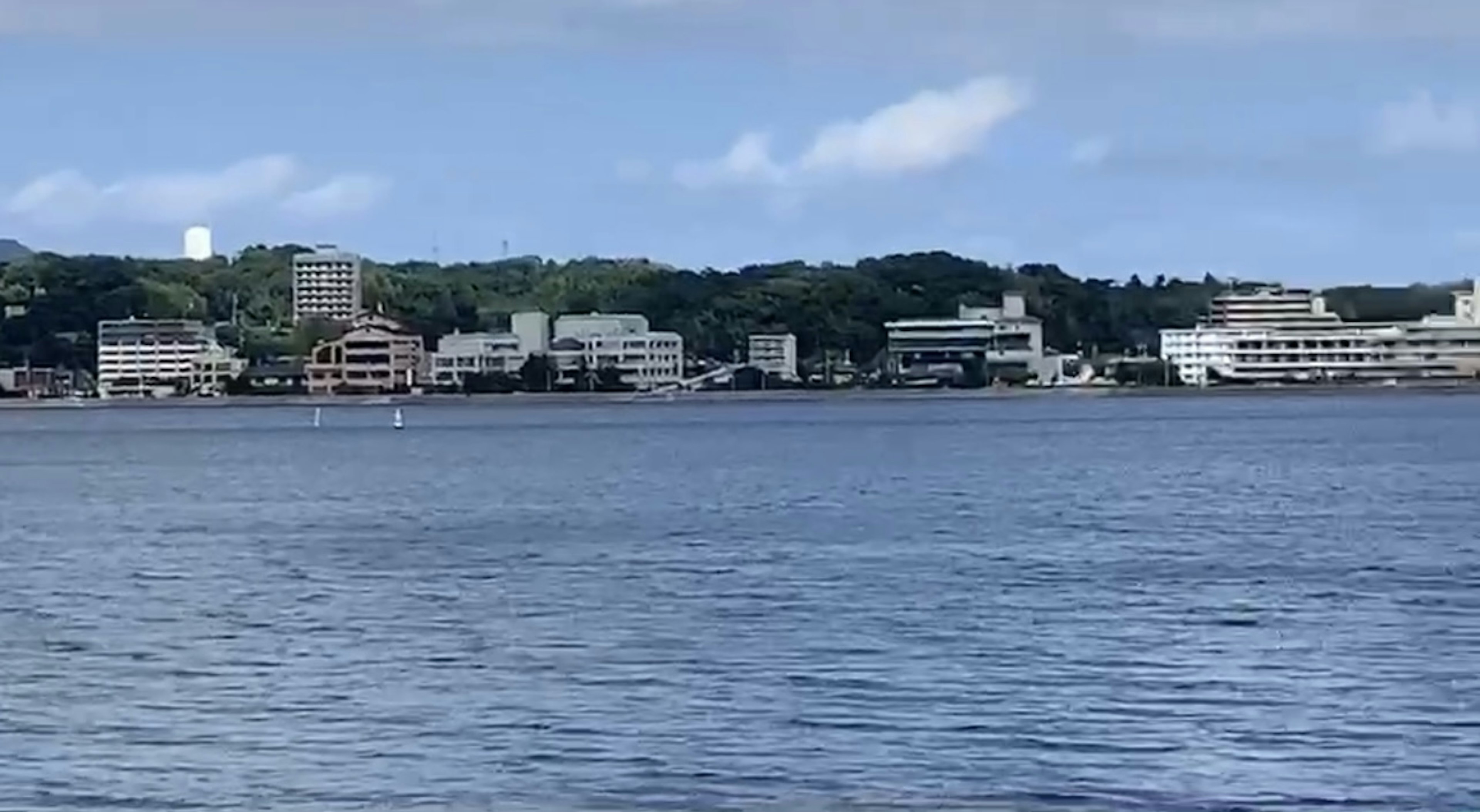 Scenic view of buildings along the waterfront with calm water