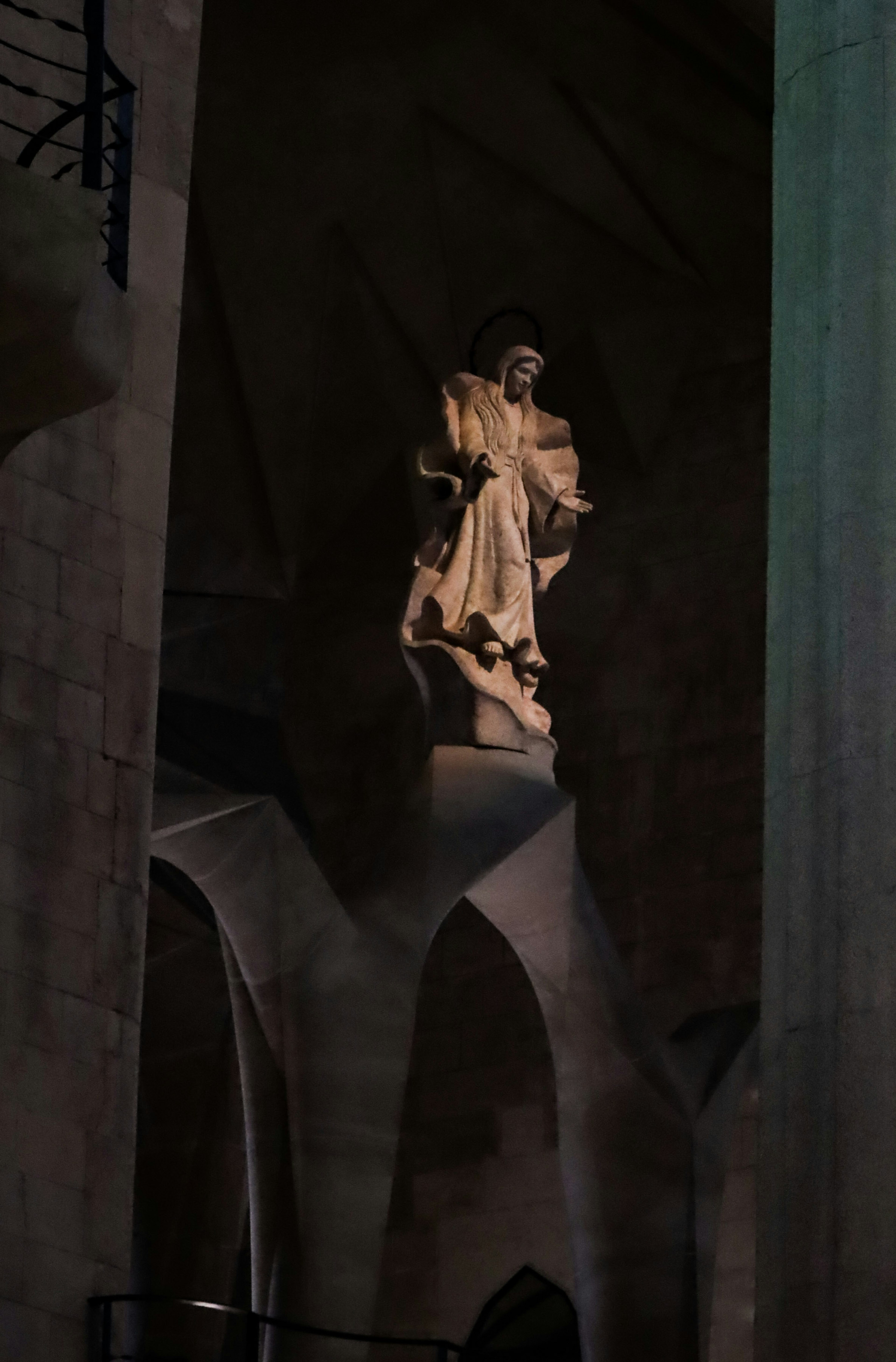 A statue standing in a dark church interior