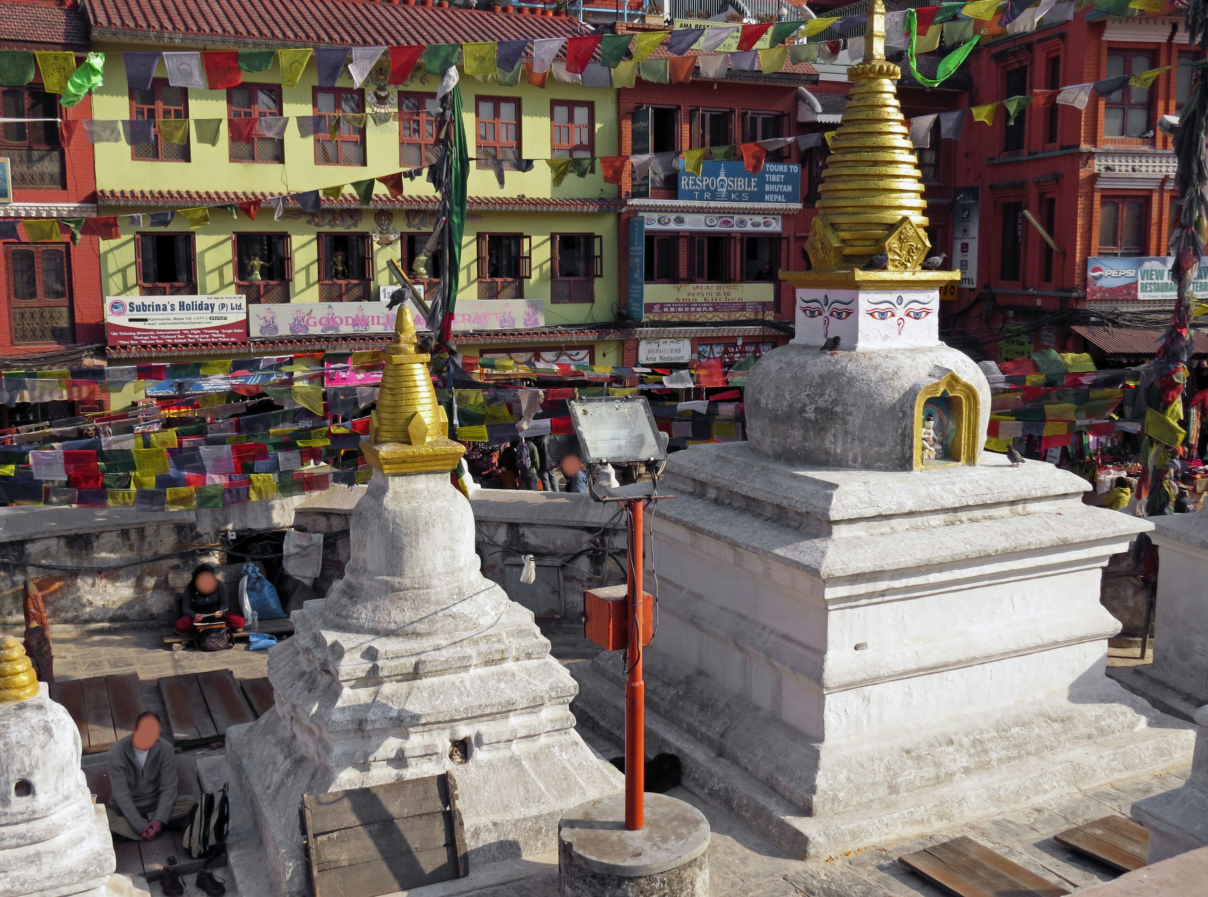 View of stupas in Kathmandu with colorful prayer flags and vibrant buildings