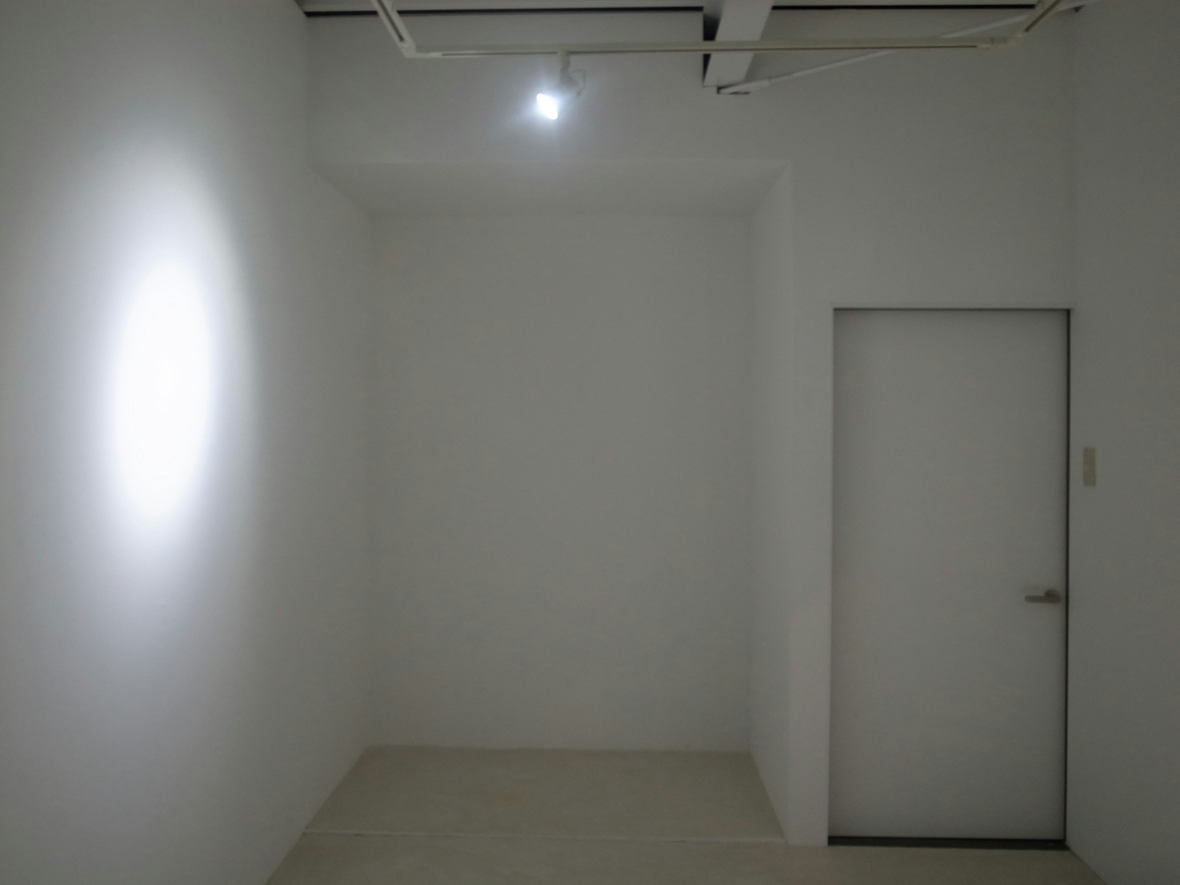 Interior of a simple room with white walls and a door