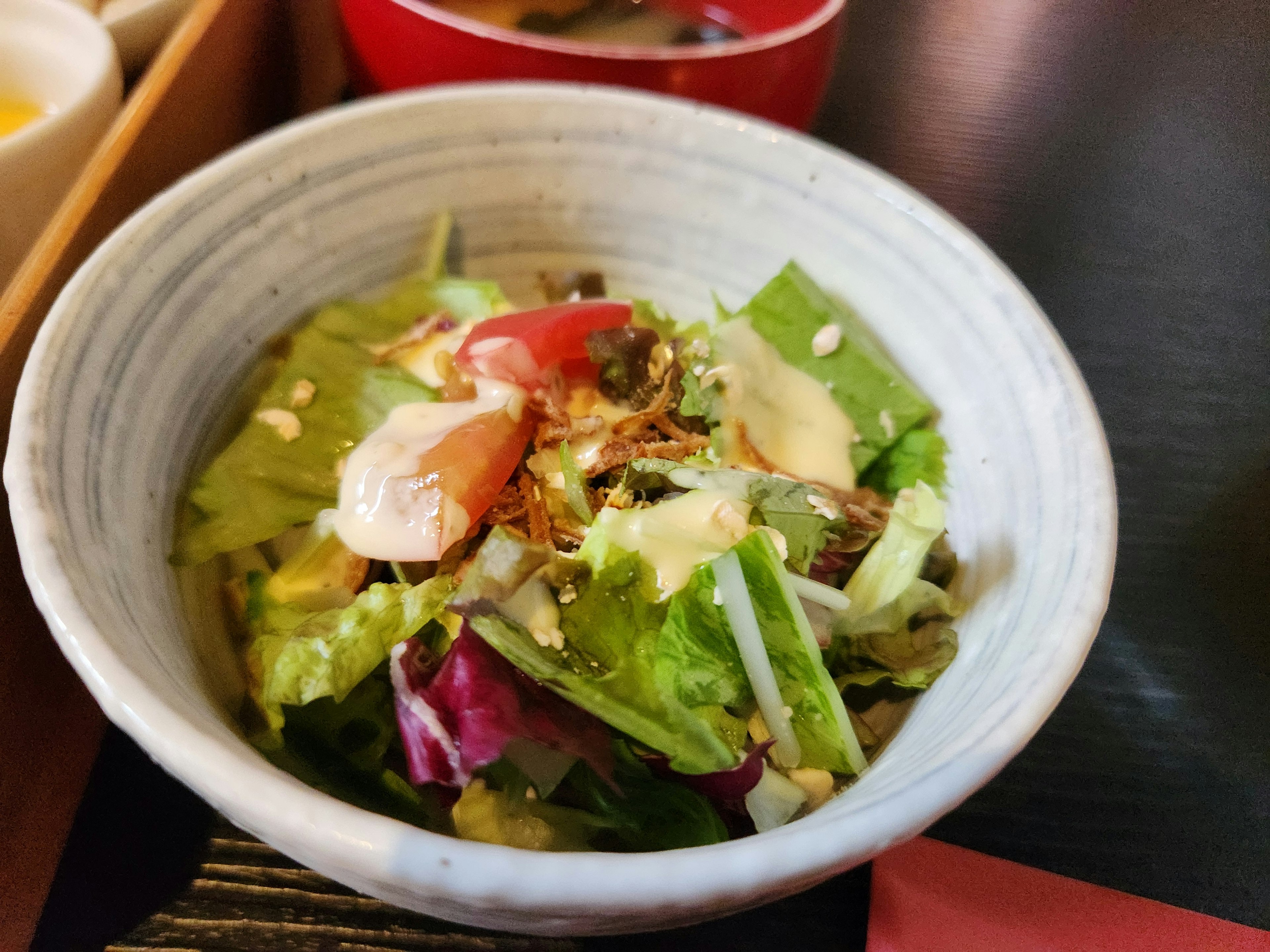 Fresh salad served in a white bowl