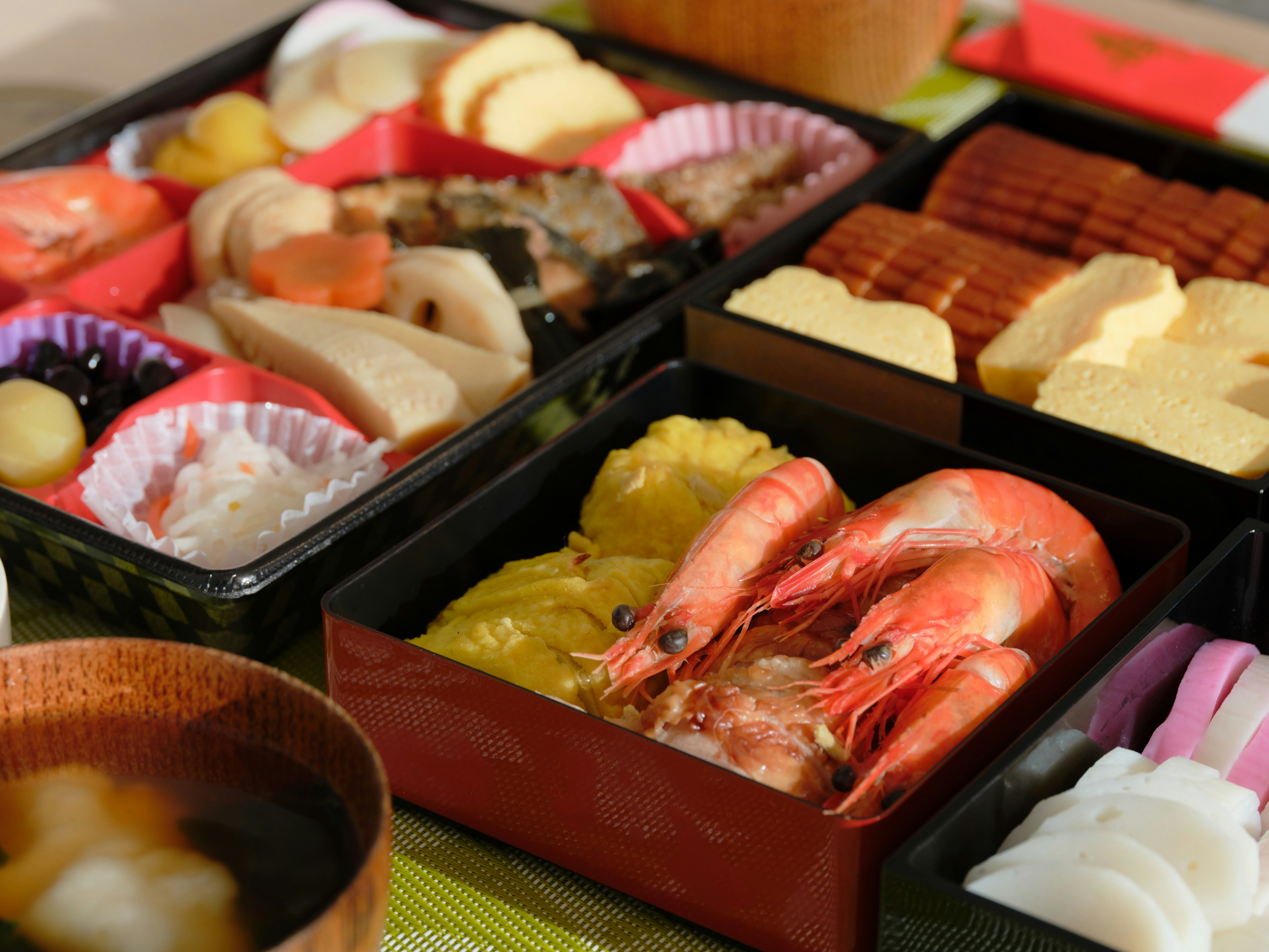 Colorful assortment of traditional Japanese cuisine beautifully arranged in bento boxes