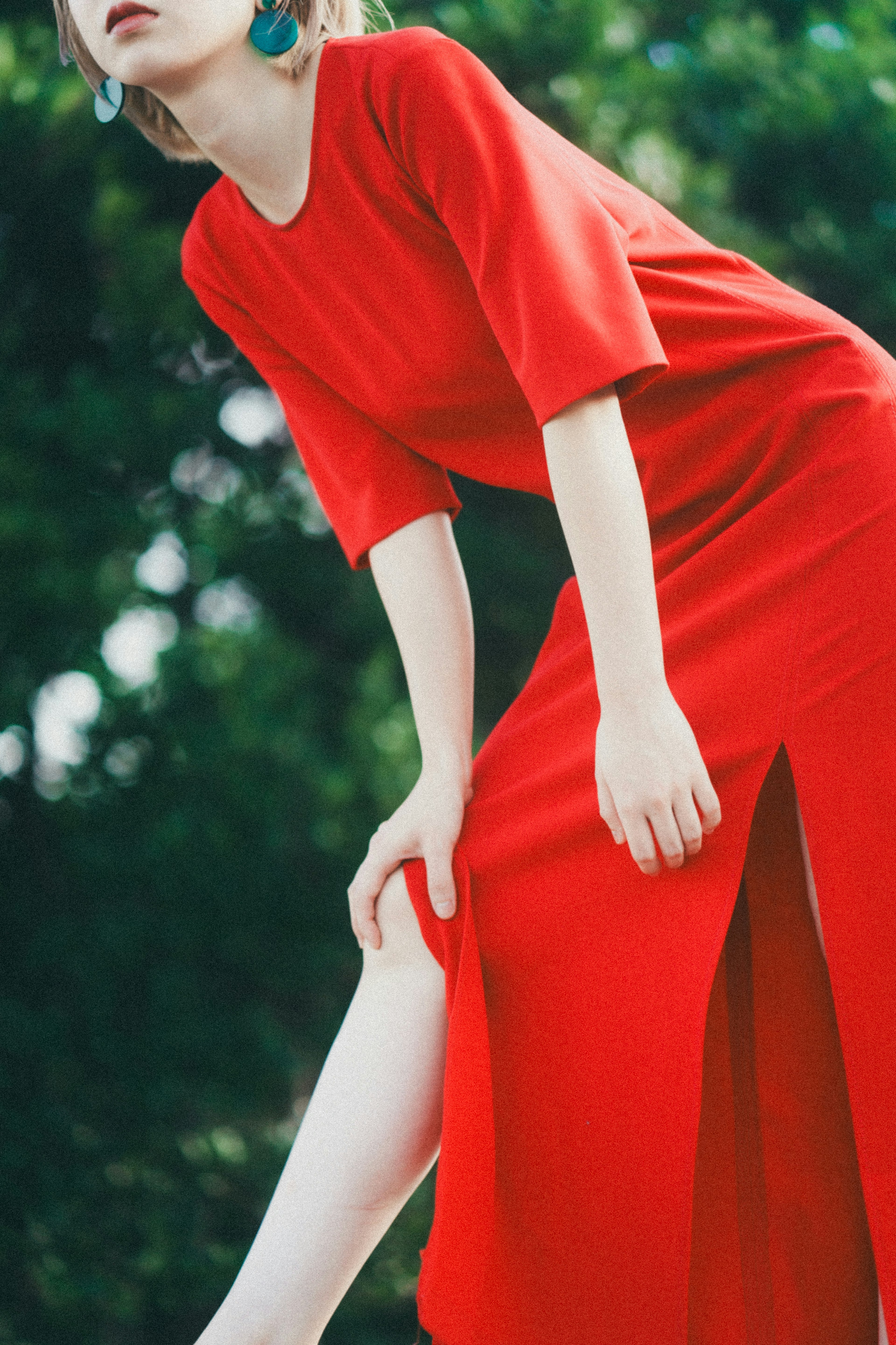 Modelo posando en un vibrante vestido rojo con una abertura alta