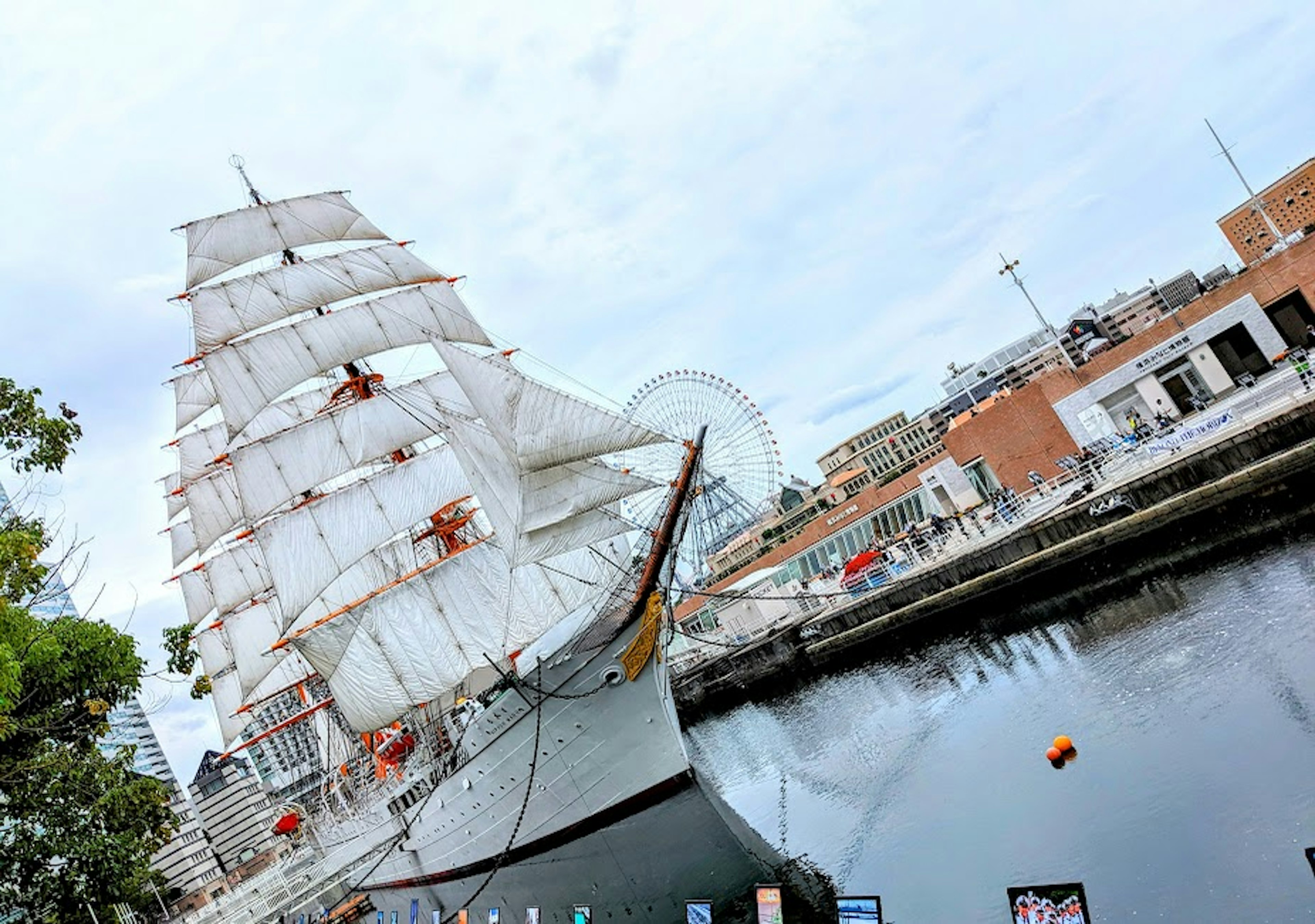 A beautiful sailing ship docked by the waterfront