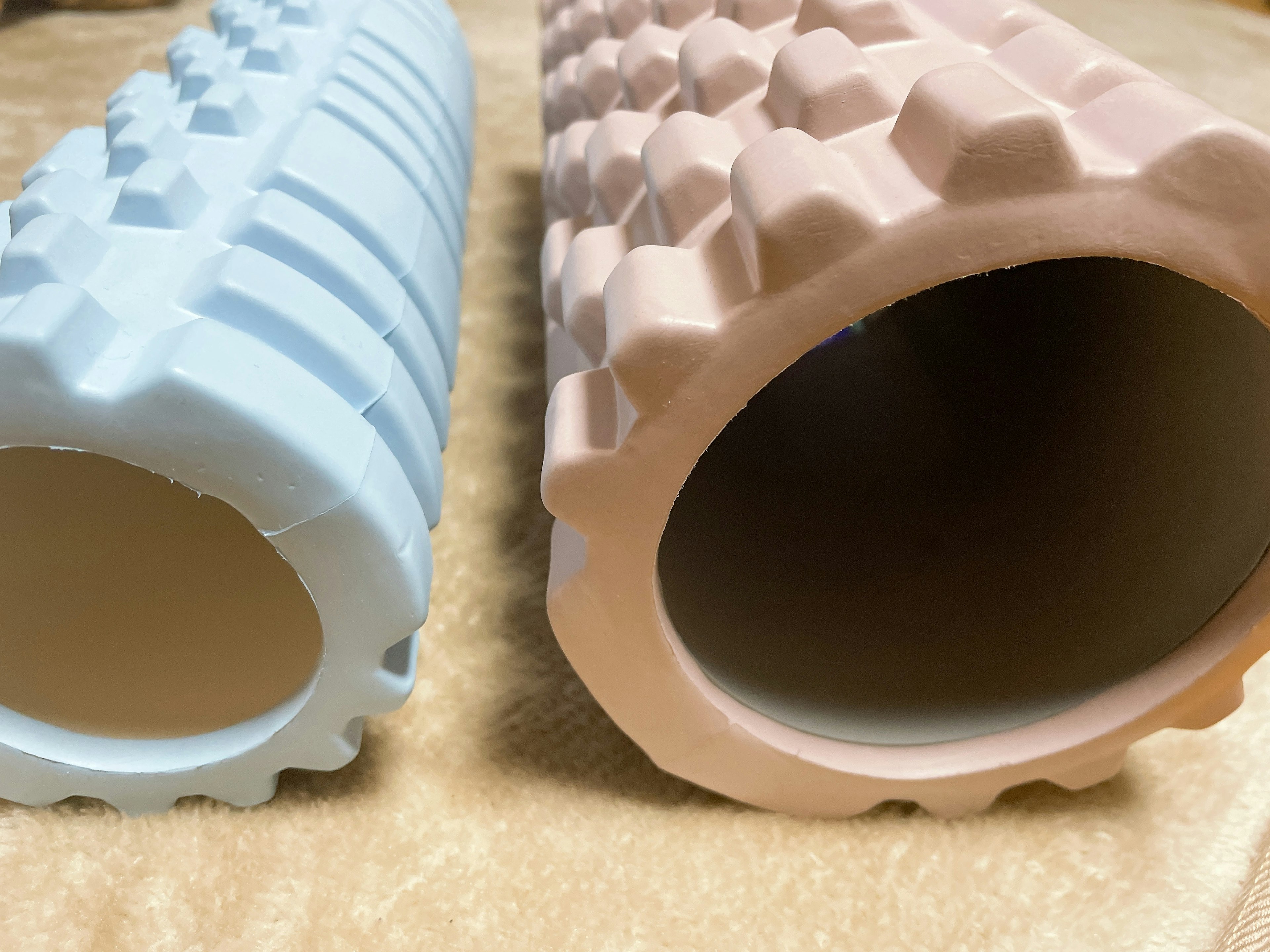 Blue and pink foam rollers side by side