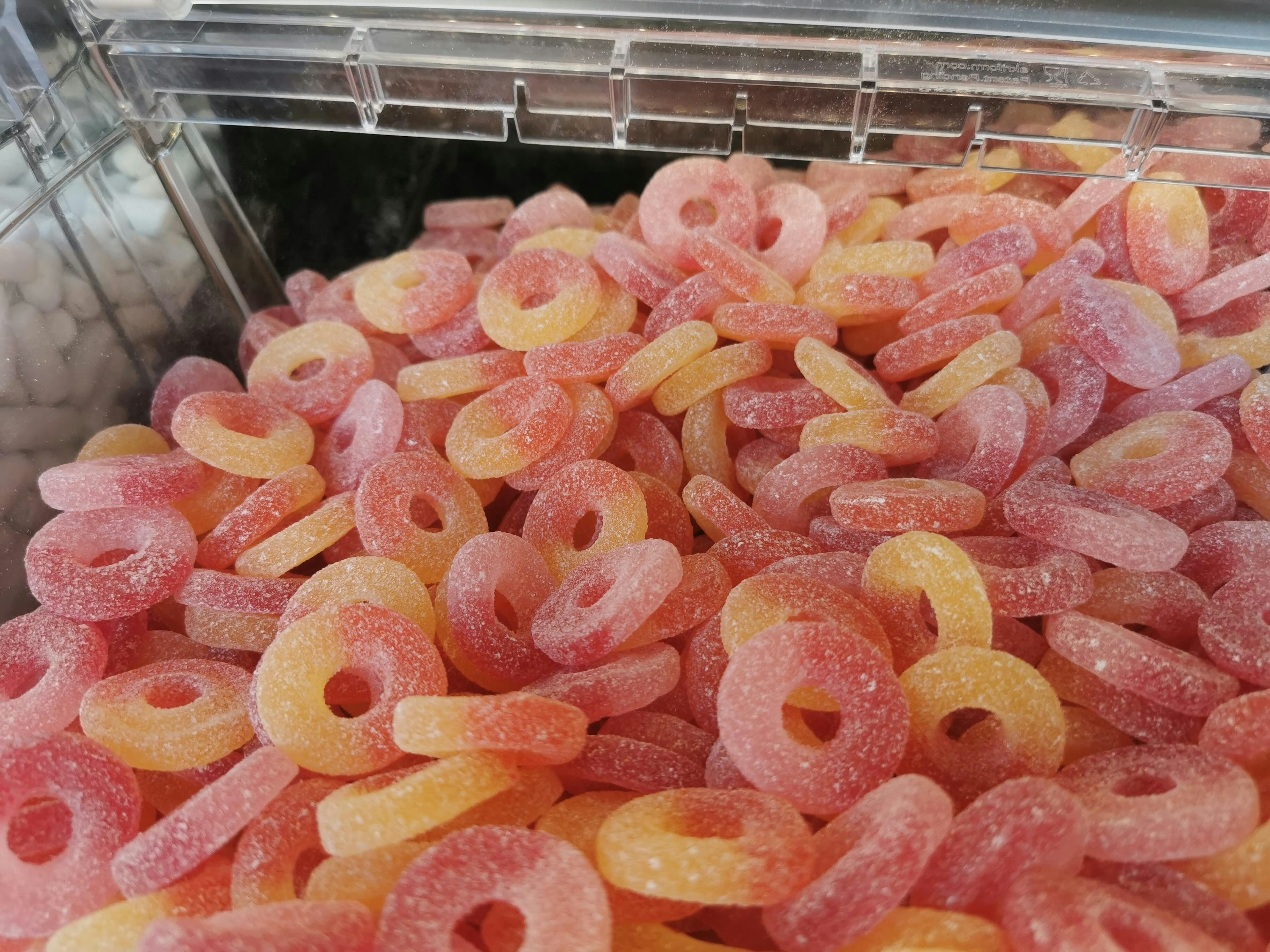 Colorful gummy ring candies packed in a transparent container