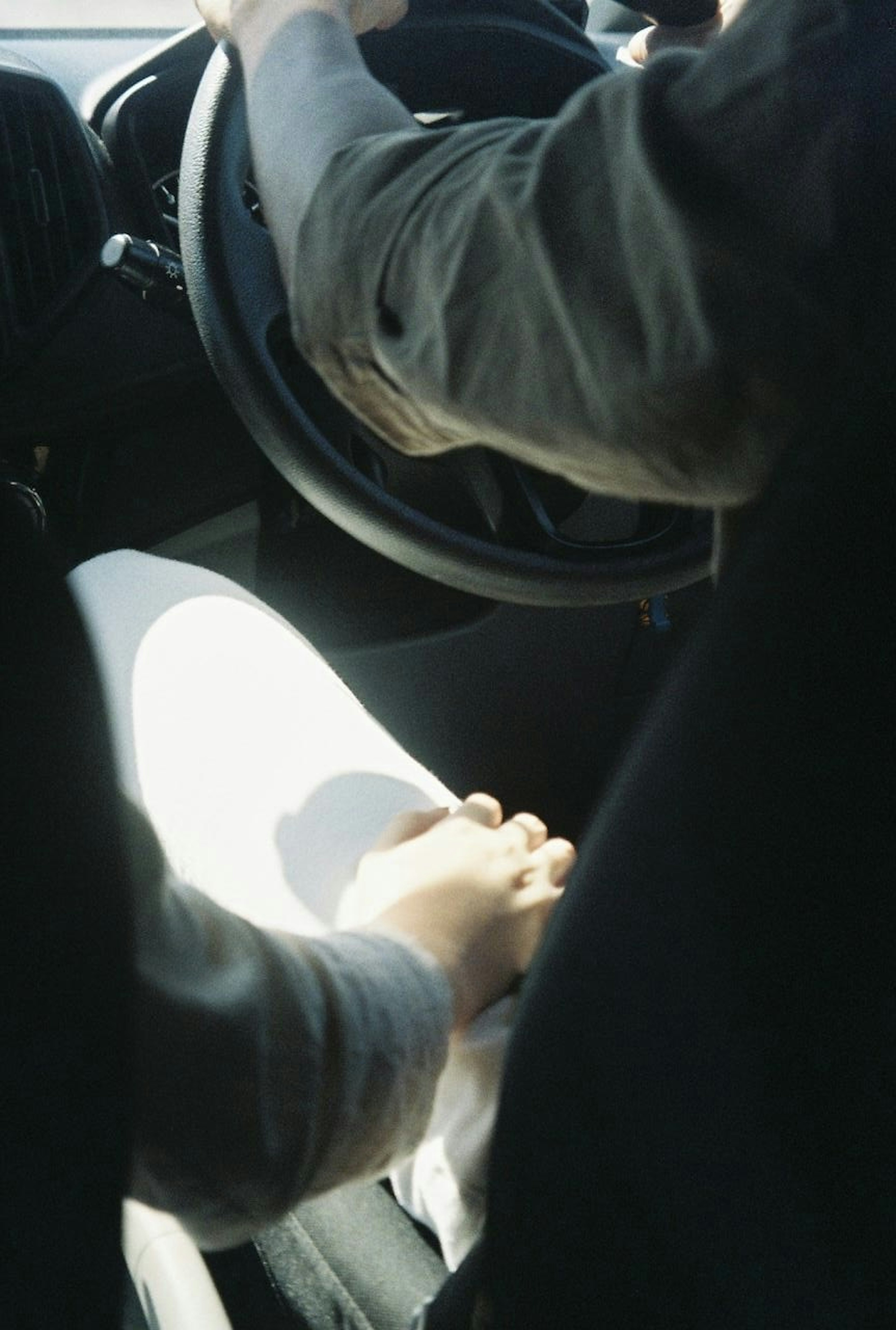 Couple holding hands while driving in a car