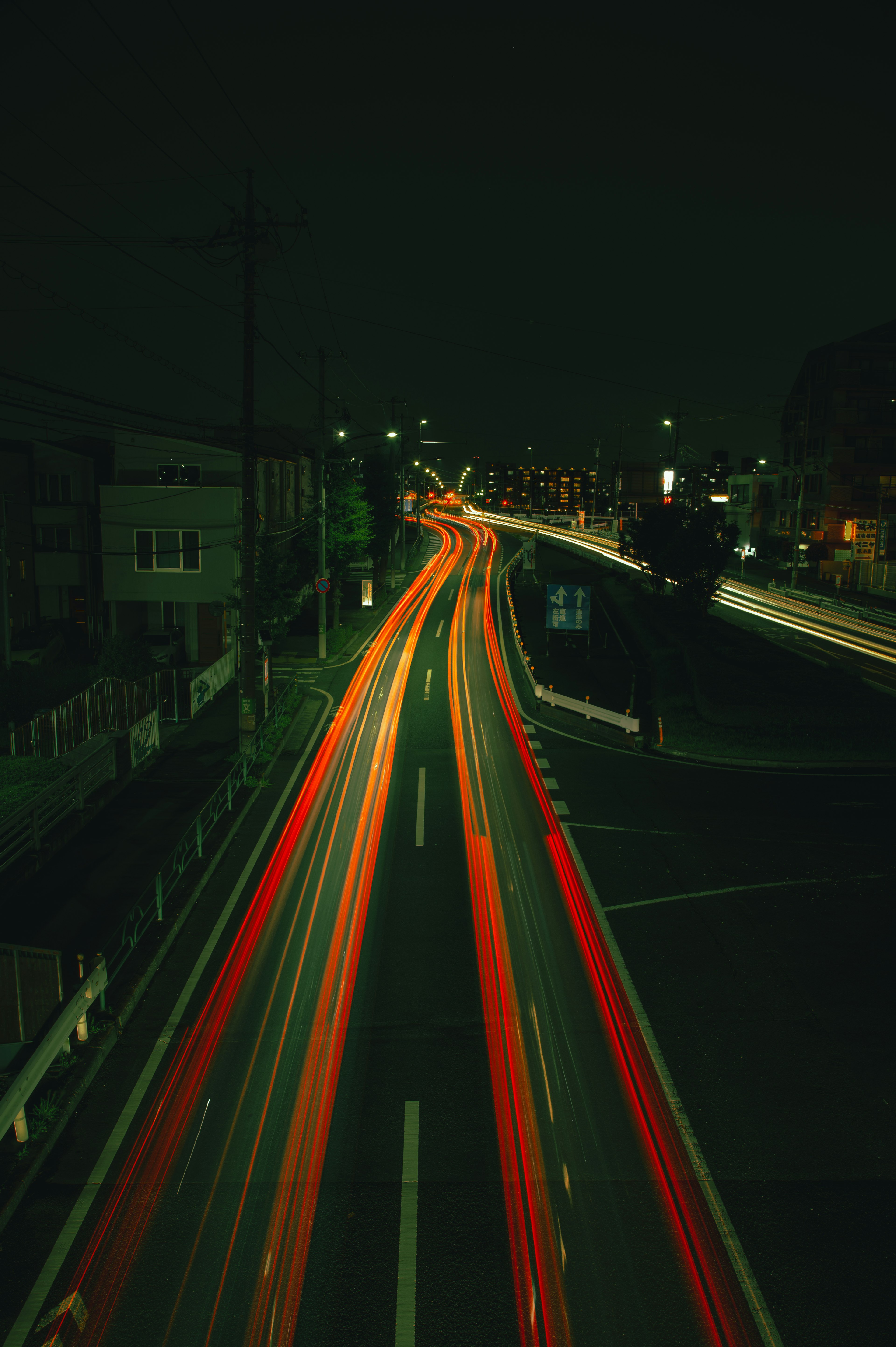 Light trails of cars on a city road at night