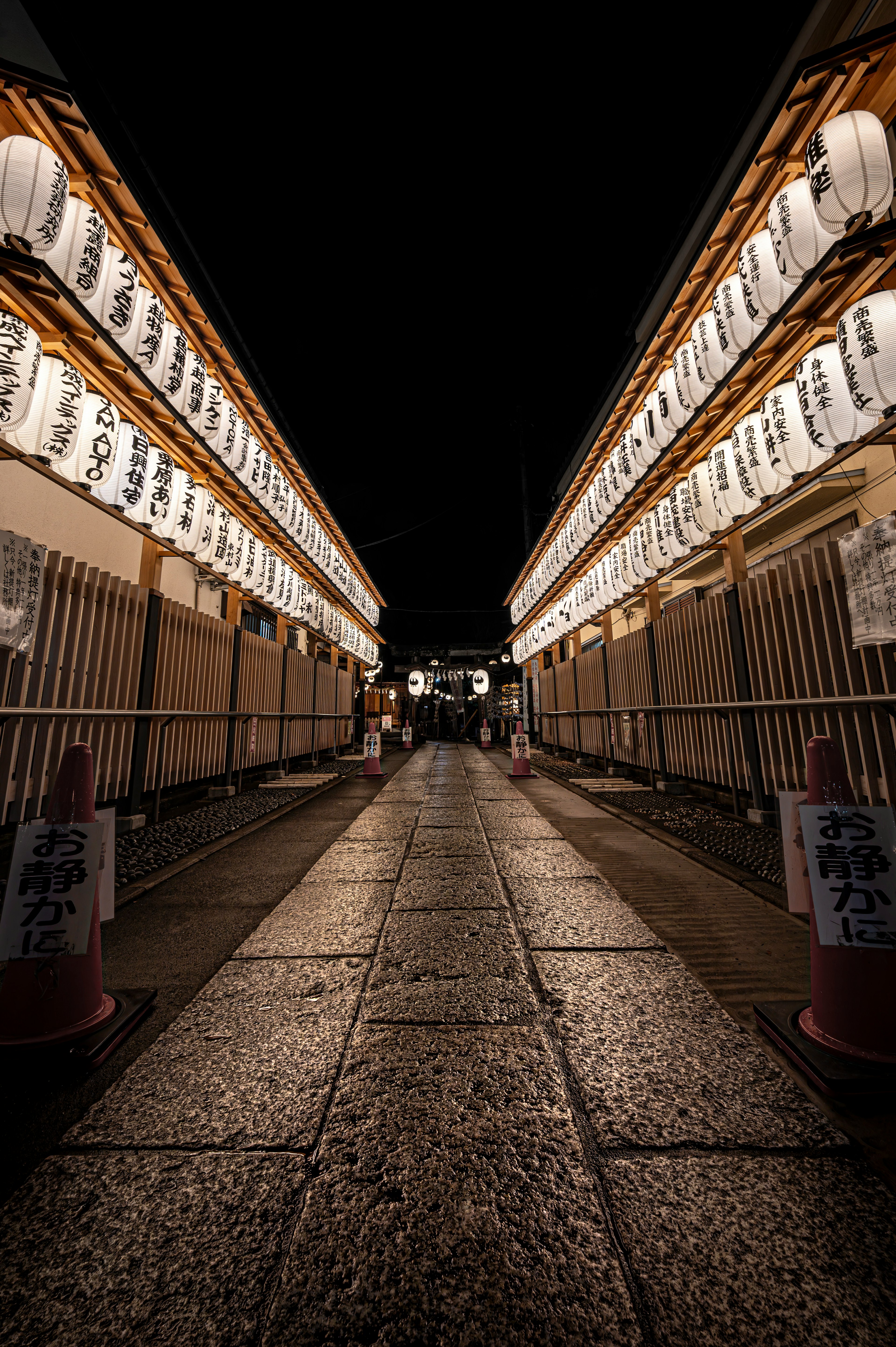 Street lined with lanterns illuminated at night