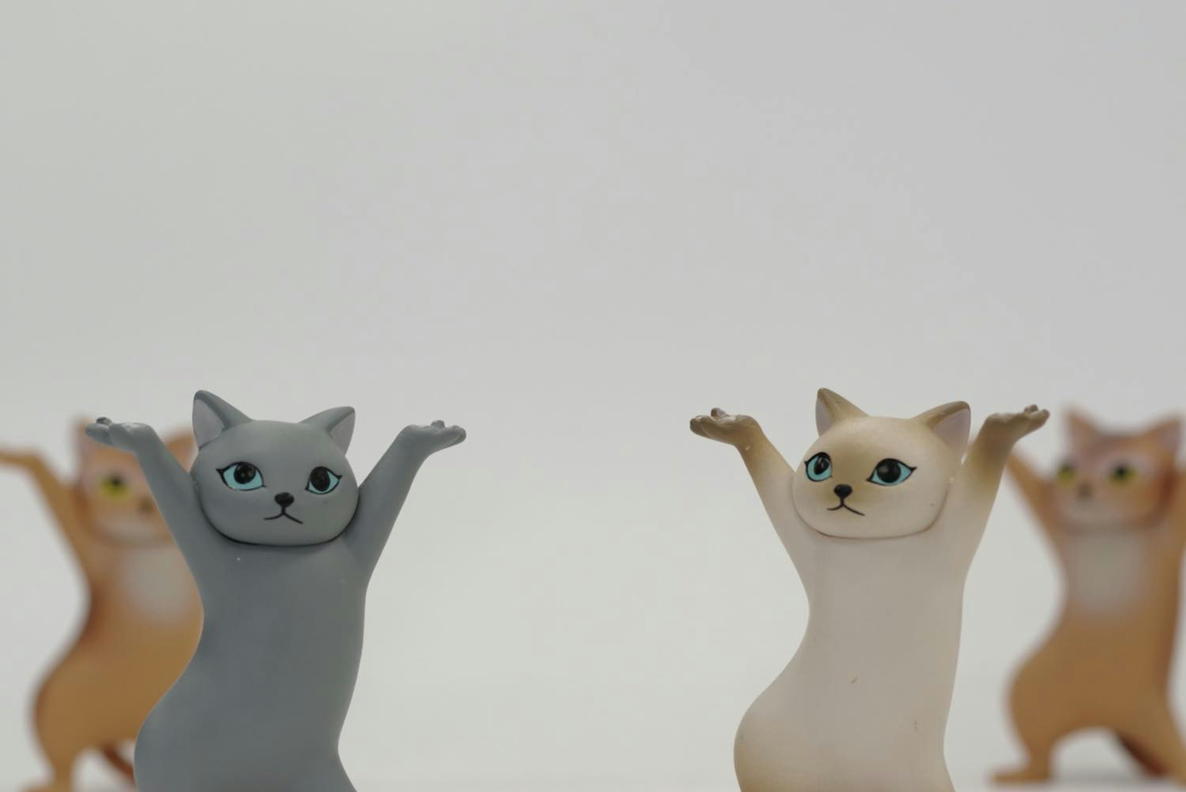 可愛い猫のフィギュアが手を上げている