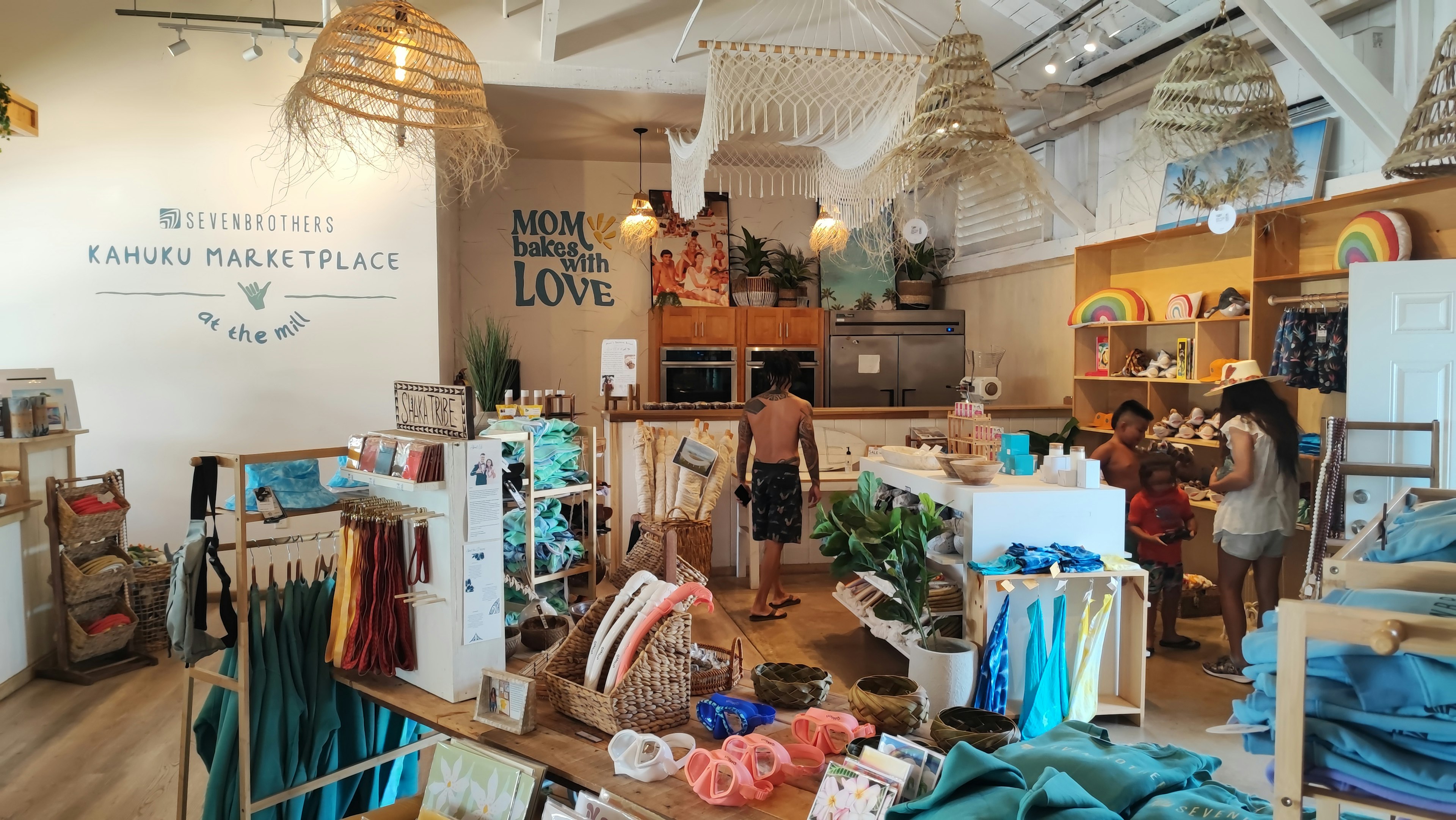 Brightly lit boutique interior with colorful merchandise displayed wall featuring the word LOVE