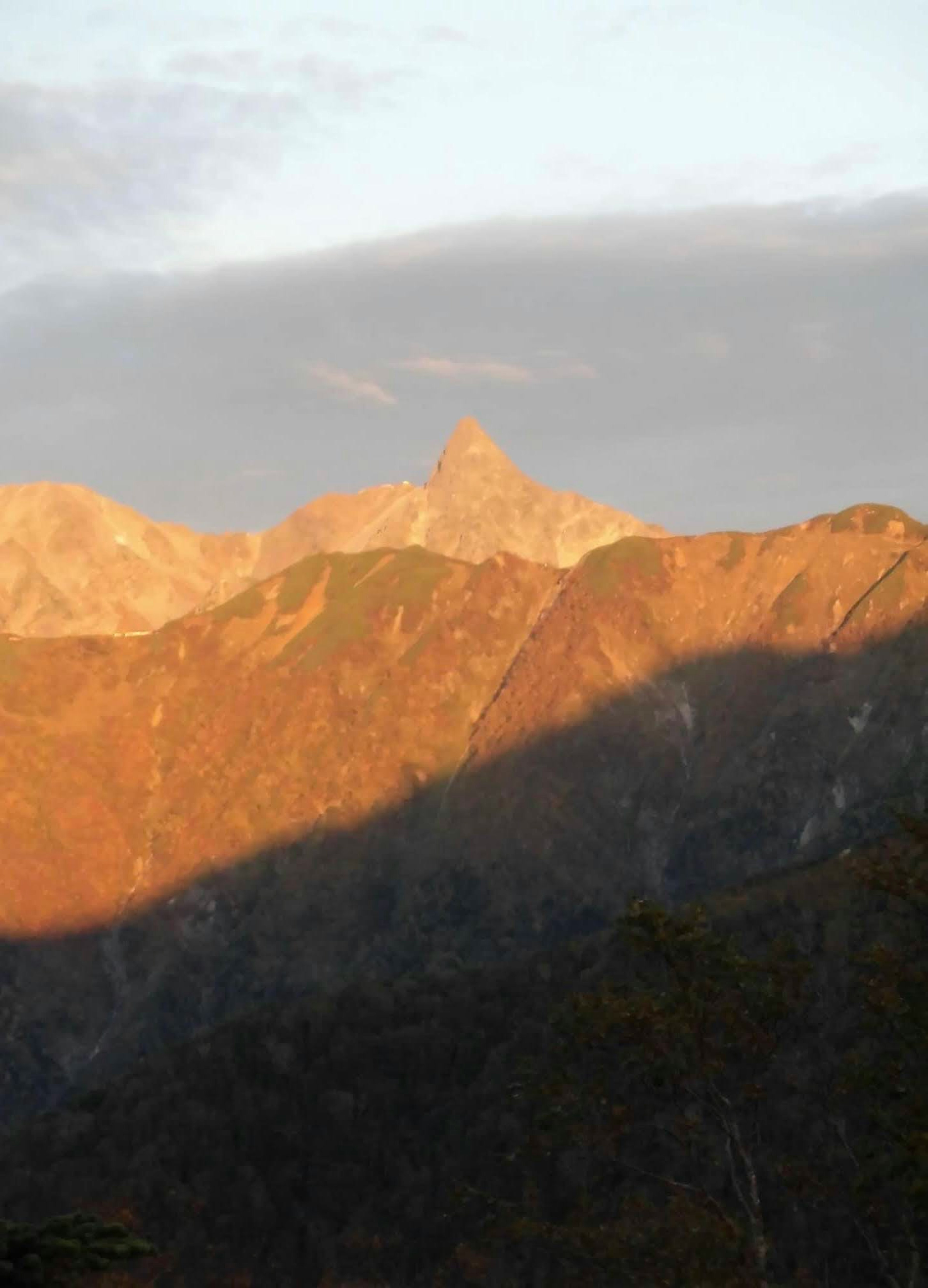 Paesaggio montano illuminato dalla luce del tramonto e dall'ombra