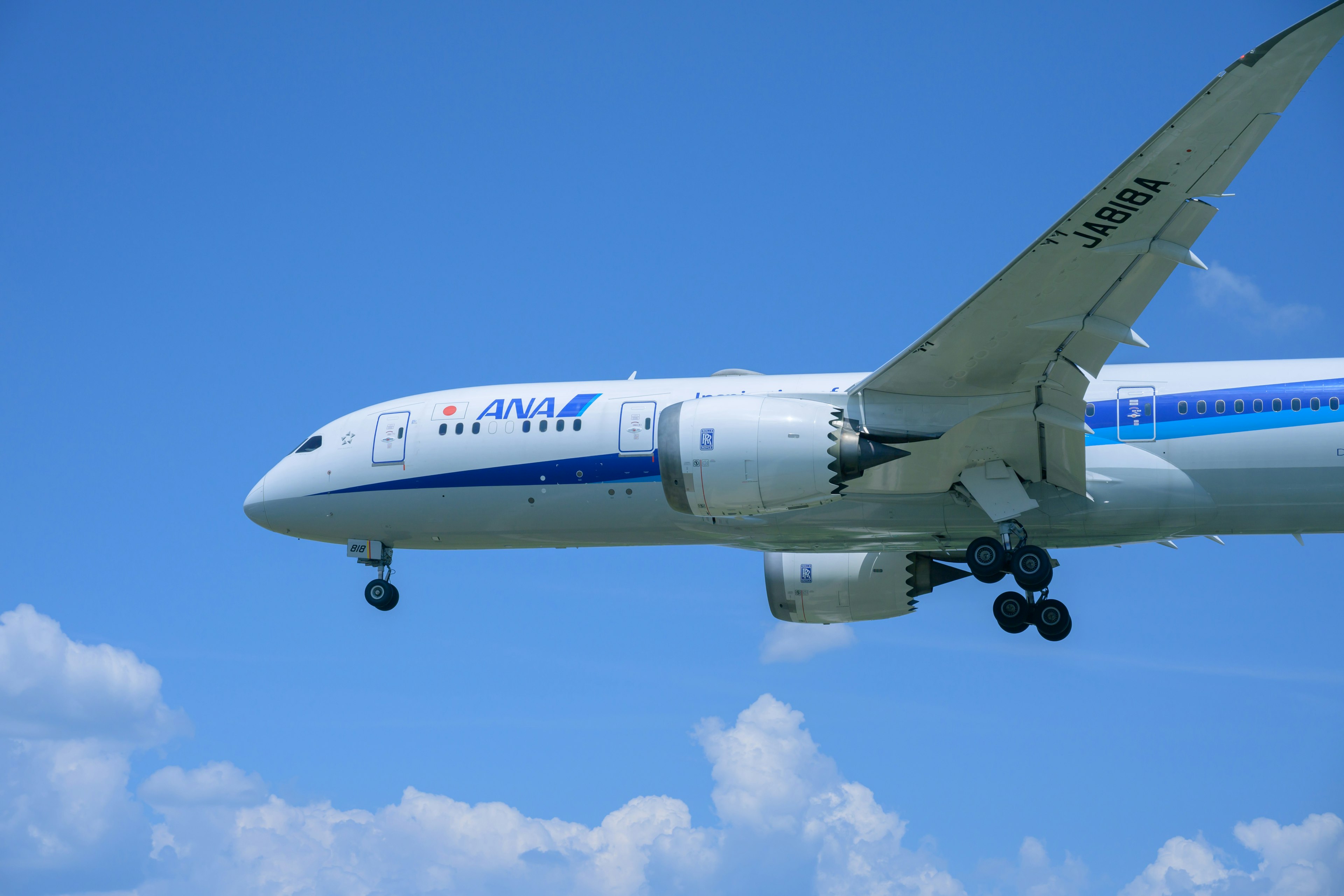 Airplane approaching against a blue sky