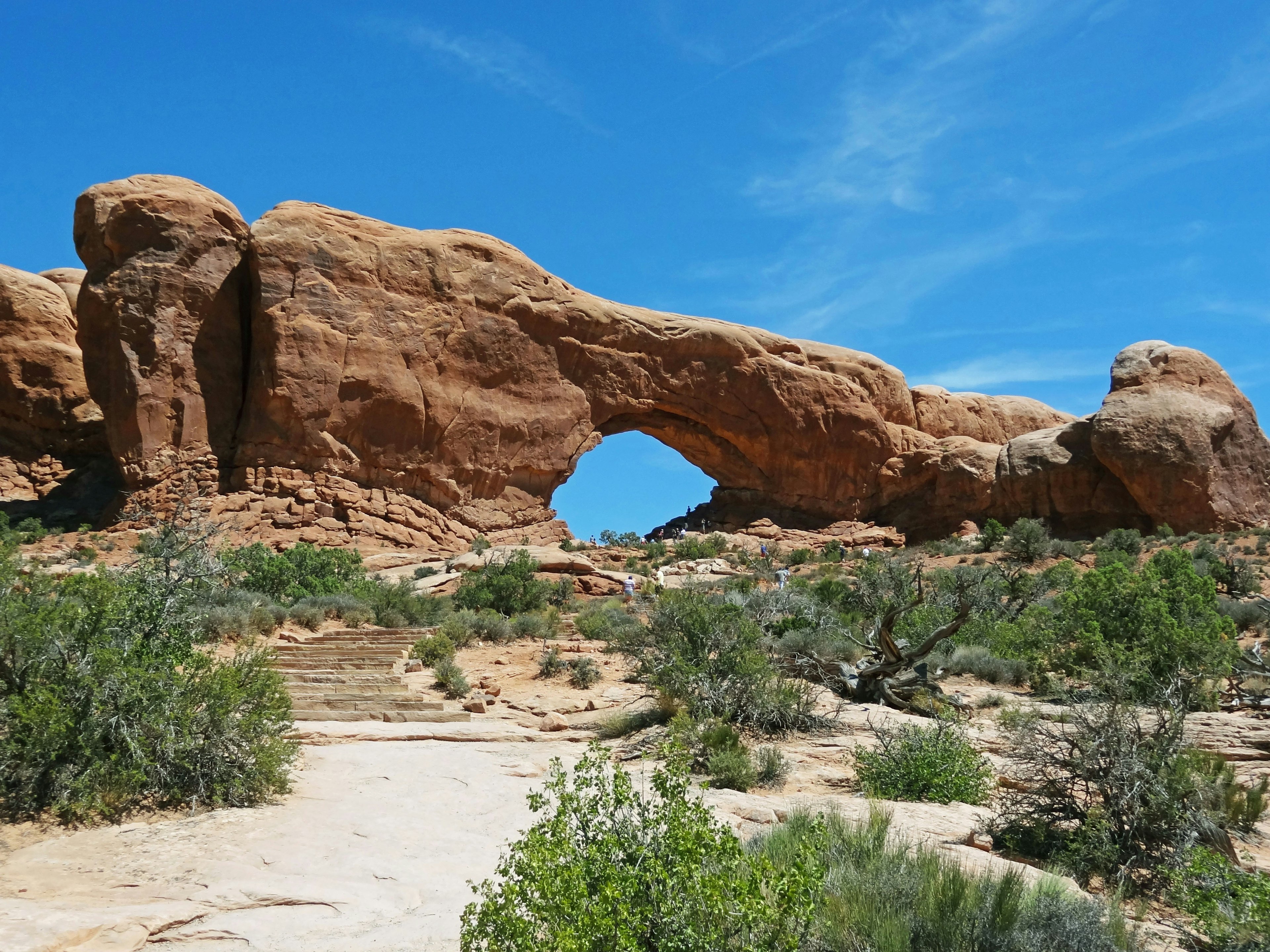 Red rock arch against a blue sky