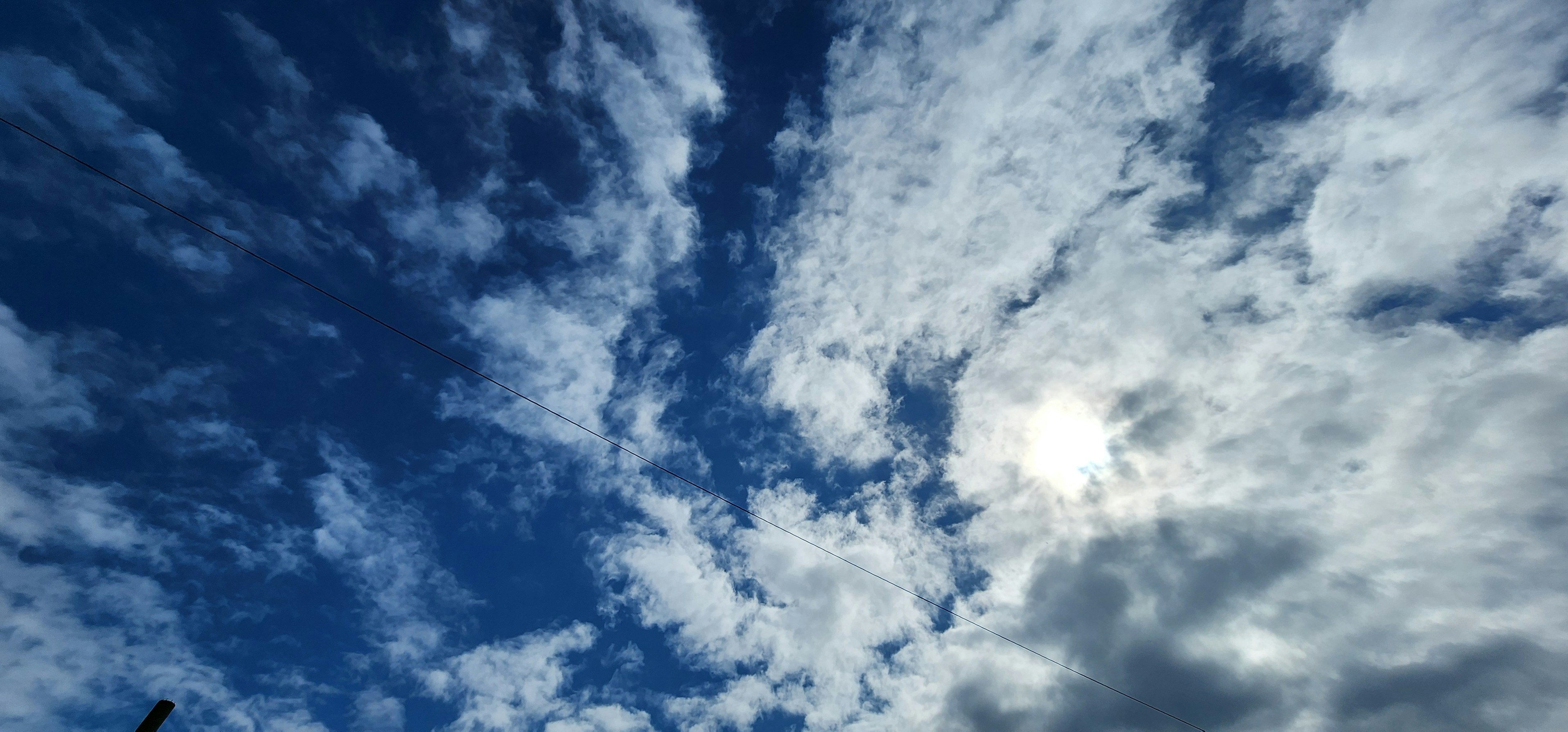 Blue sky with fluffy white clouds and sunlight