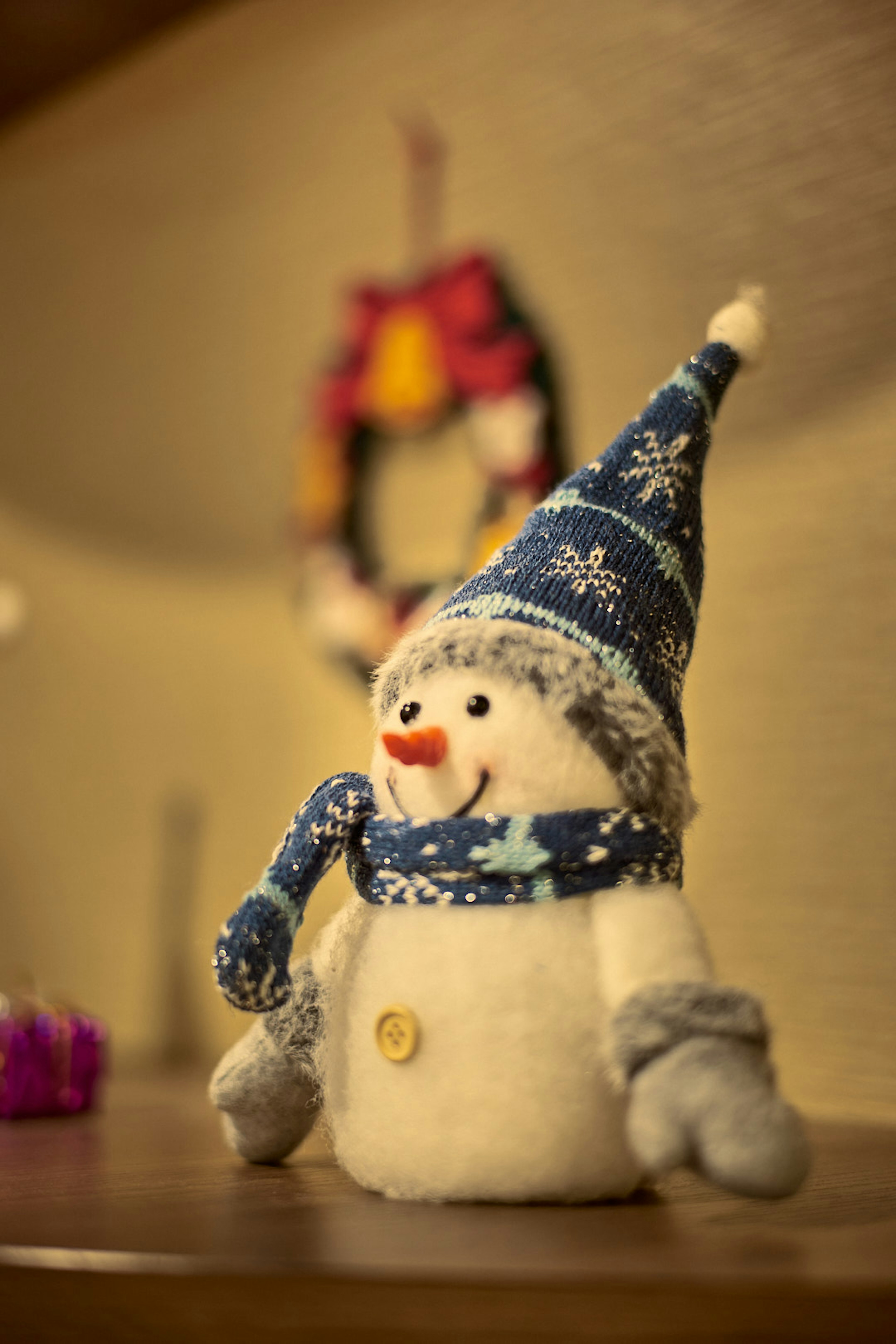 Ein niedlicher Schneemann mit einem blauen Hut und Handschuhen mit einem fröhlichen Lächeln