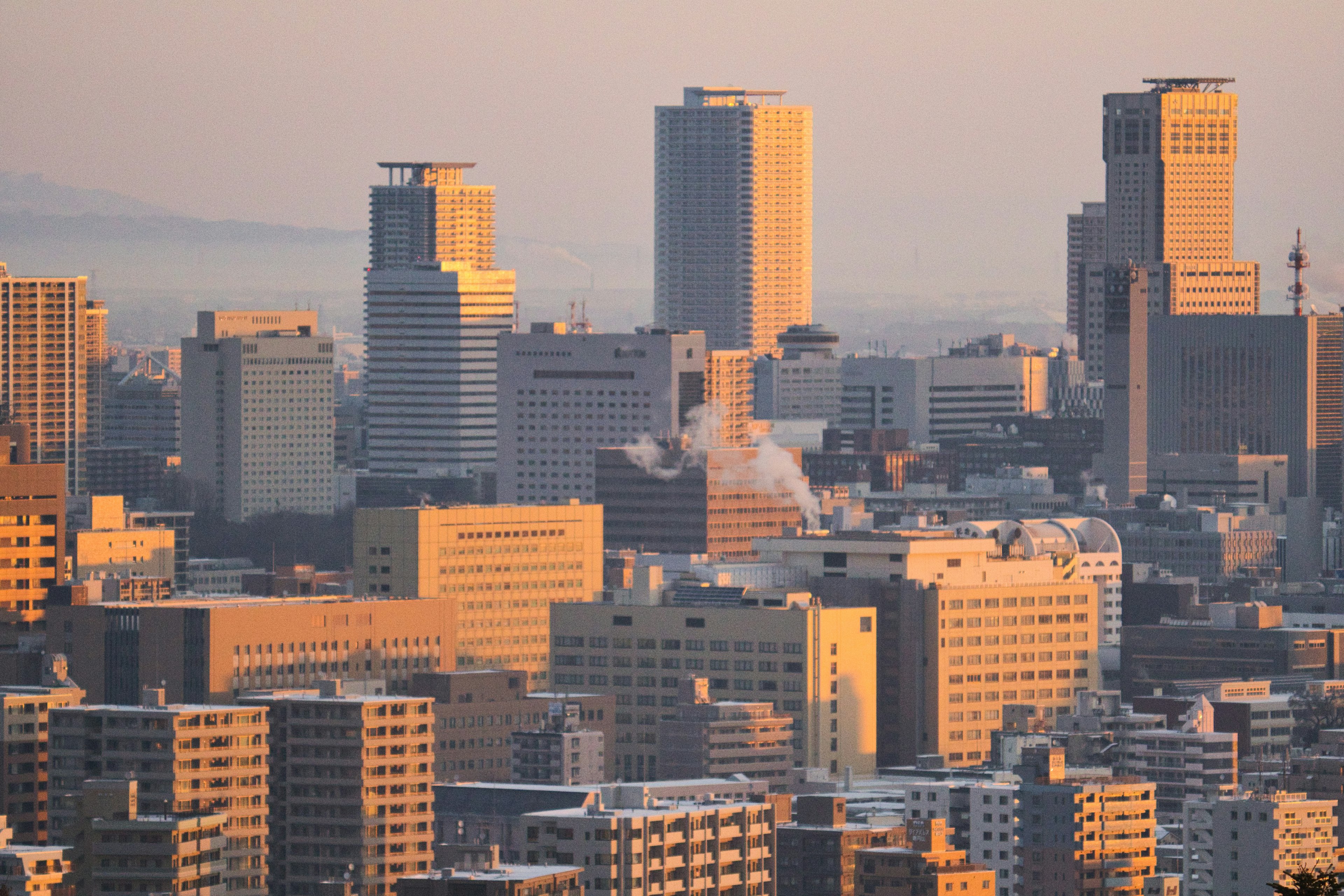 City skyline during sunset with high-rise buildings