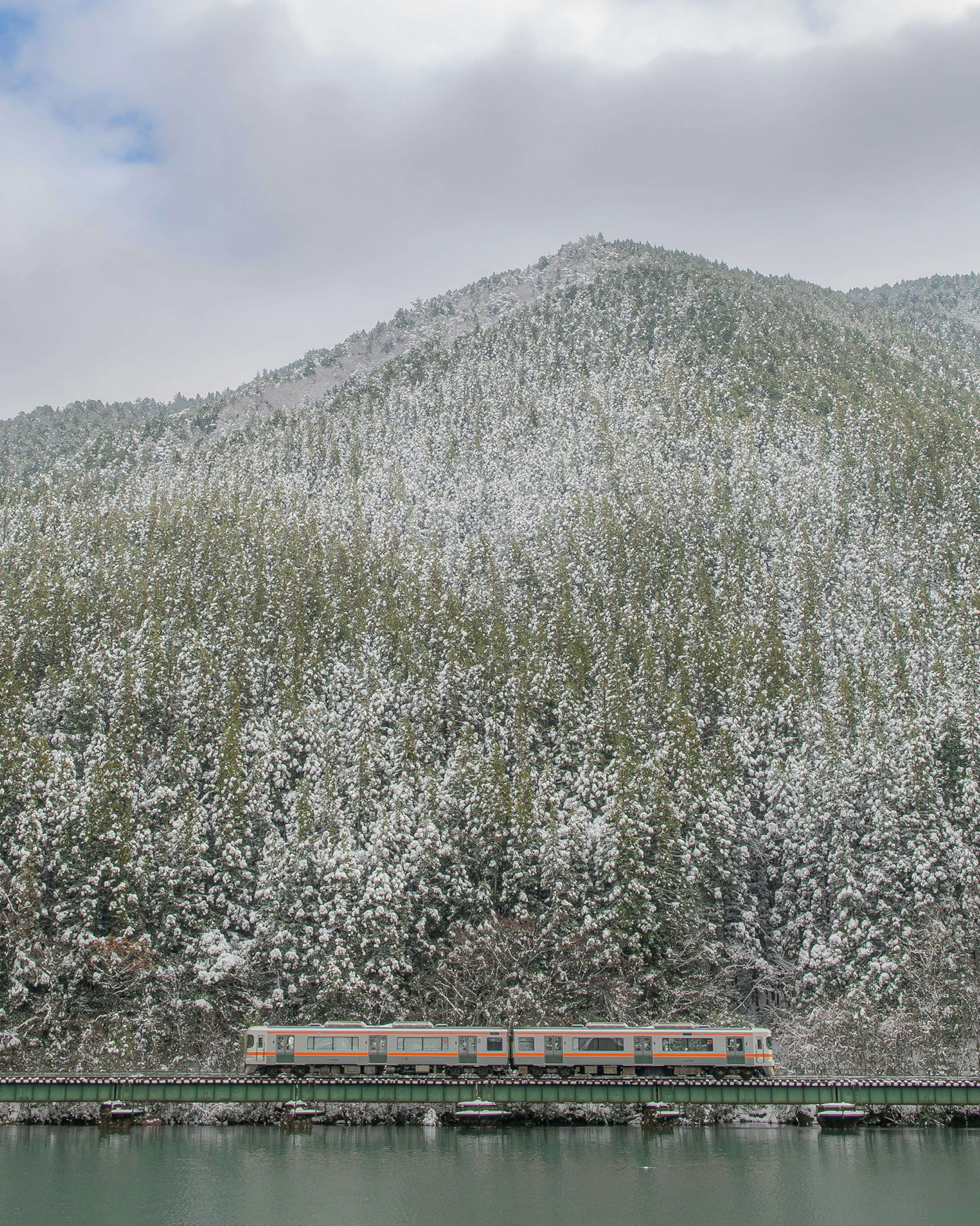 Train traveling along a snowy mountain landscape