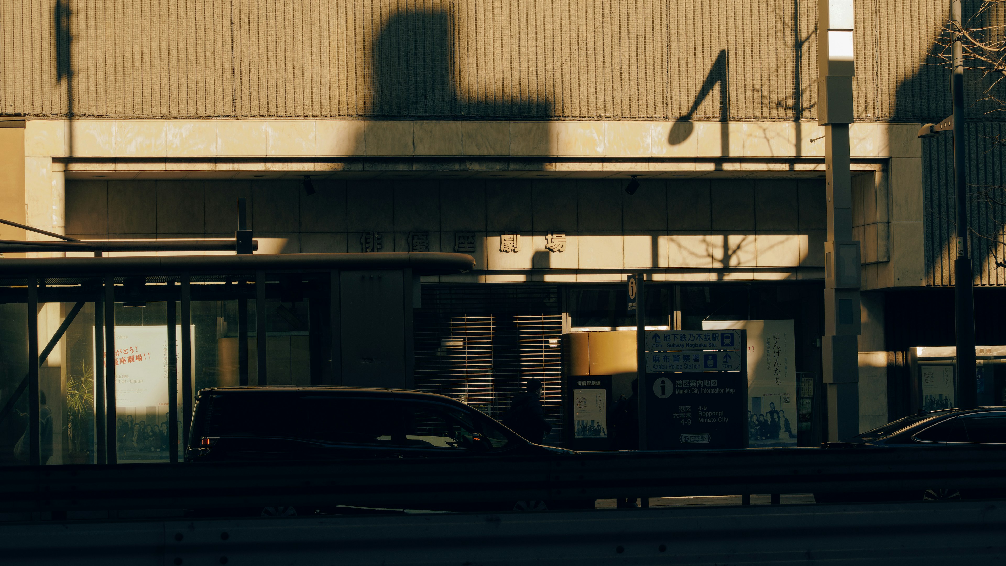 Building exterior with shadows and vehicles