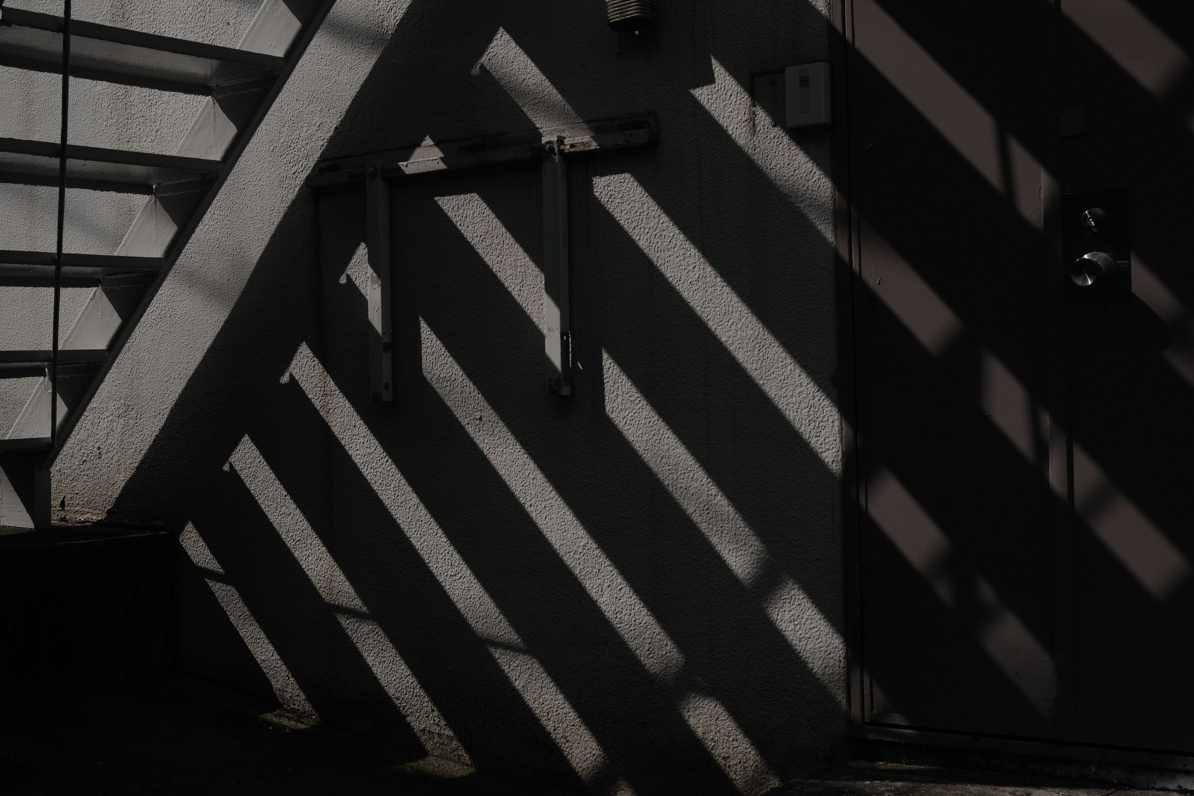 Intersecting stripes of shadow near a door