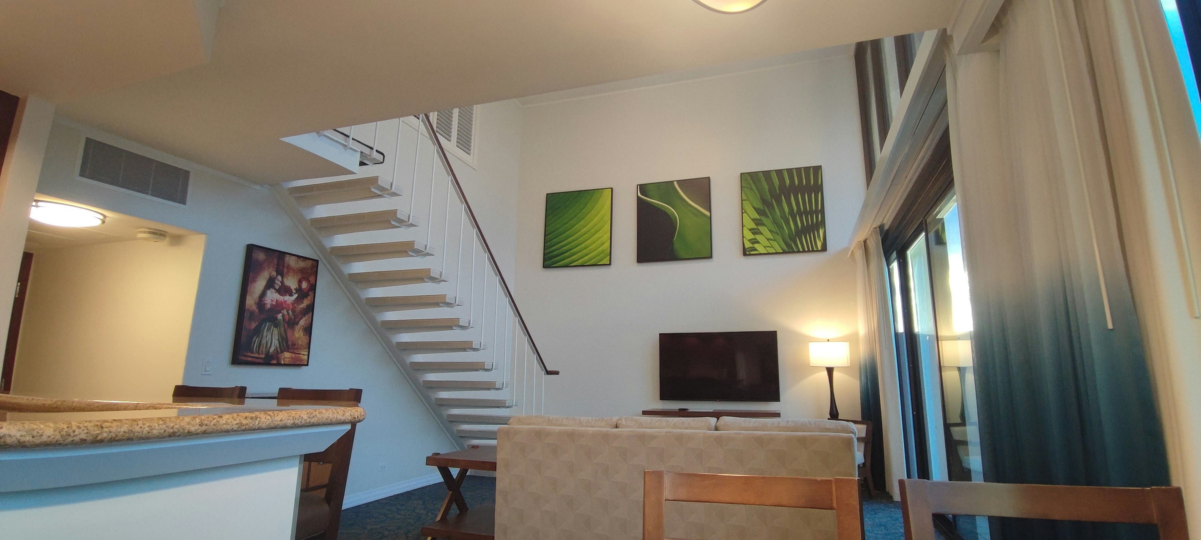 Bright living room interior featuring green artwork on the wall