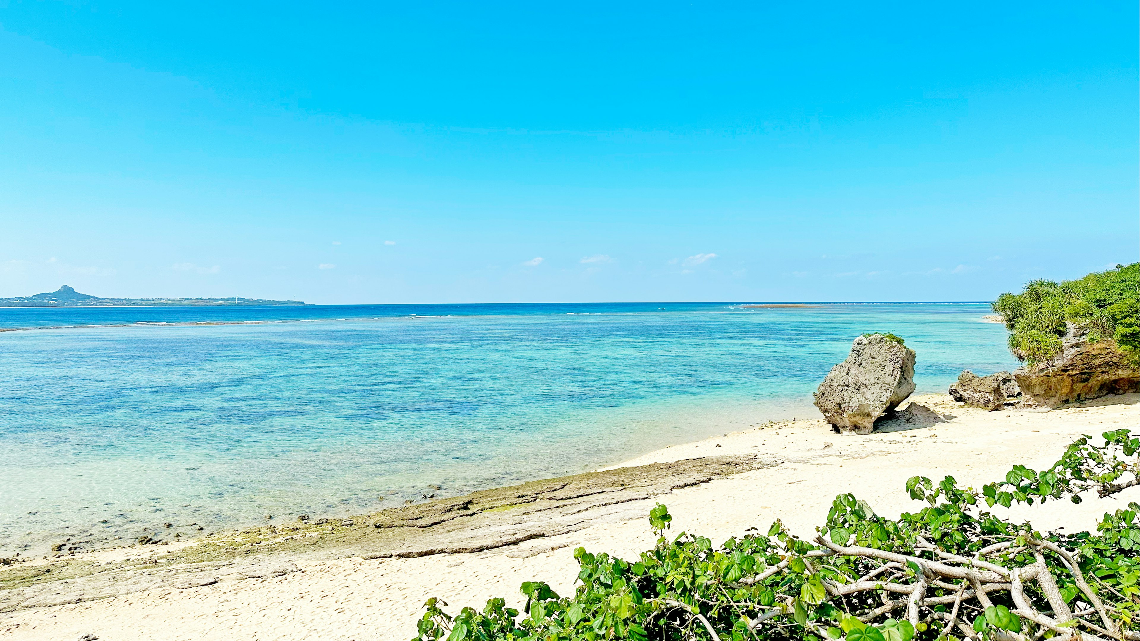 Scenic beach view with clear blue sky and turquoise water