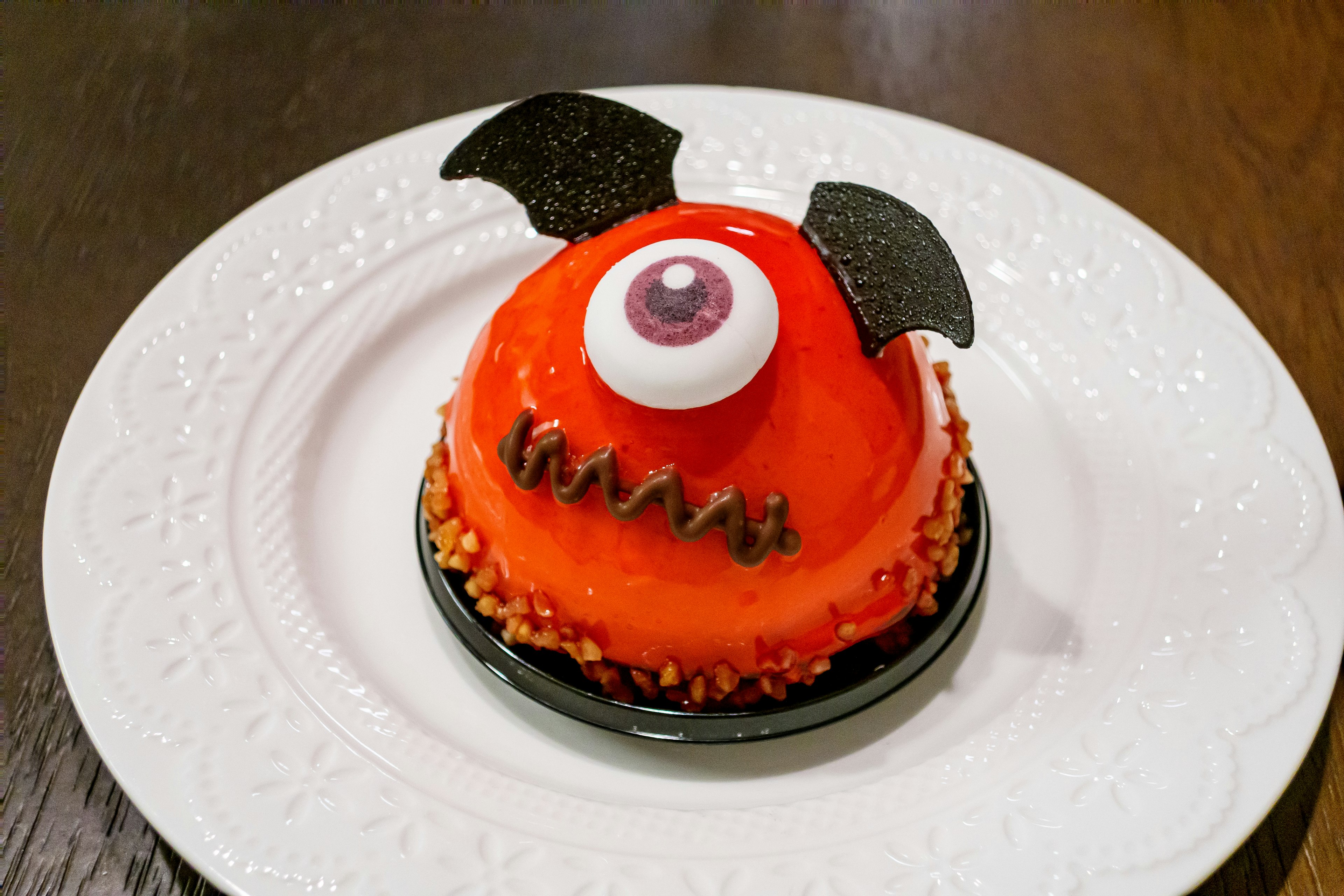 red monster cake with a large eye and black wings